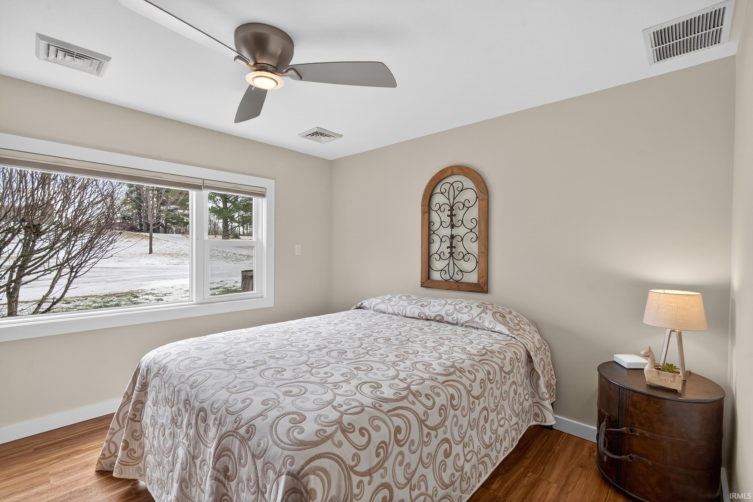 Bedroom featuring wood finished floors and a ceiling fan