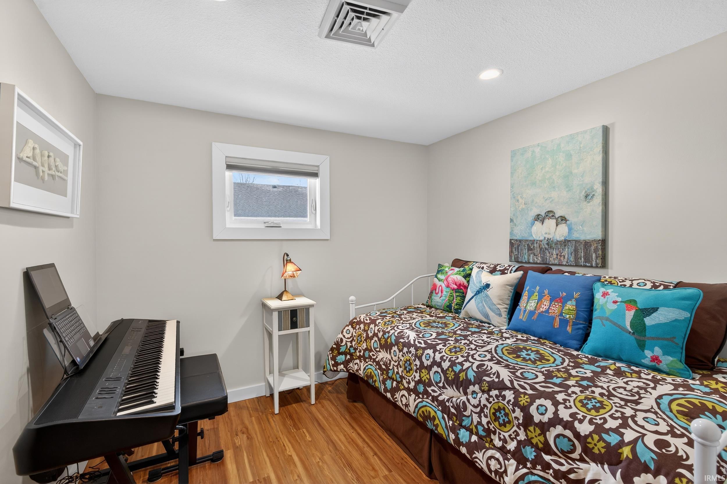 Bedroom with light wood-style flooring and baseboards