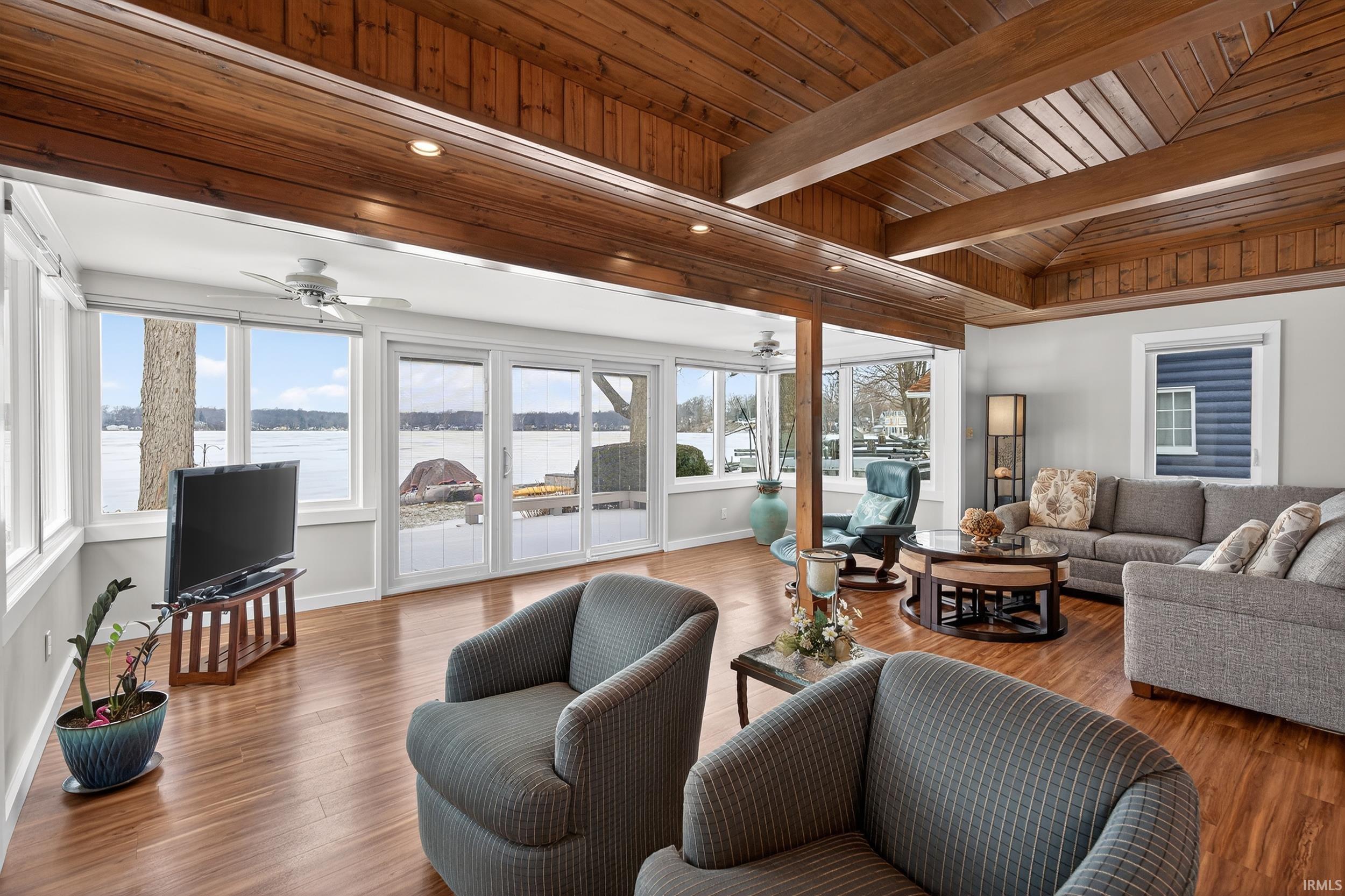 Living room with a ceiling fan, a wood ceiling with exposed beams, wood finished floors, and recessed lighting