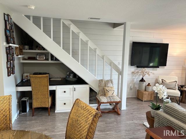 Living room with built in desk and dark wood finished floors
