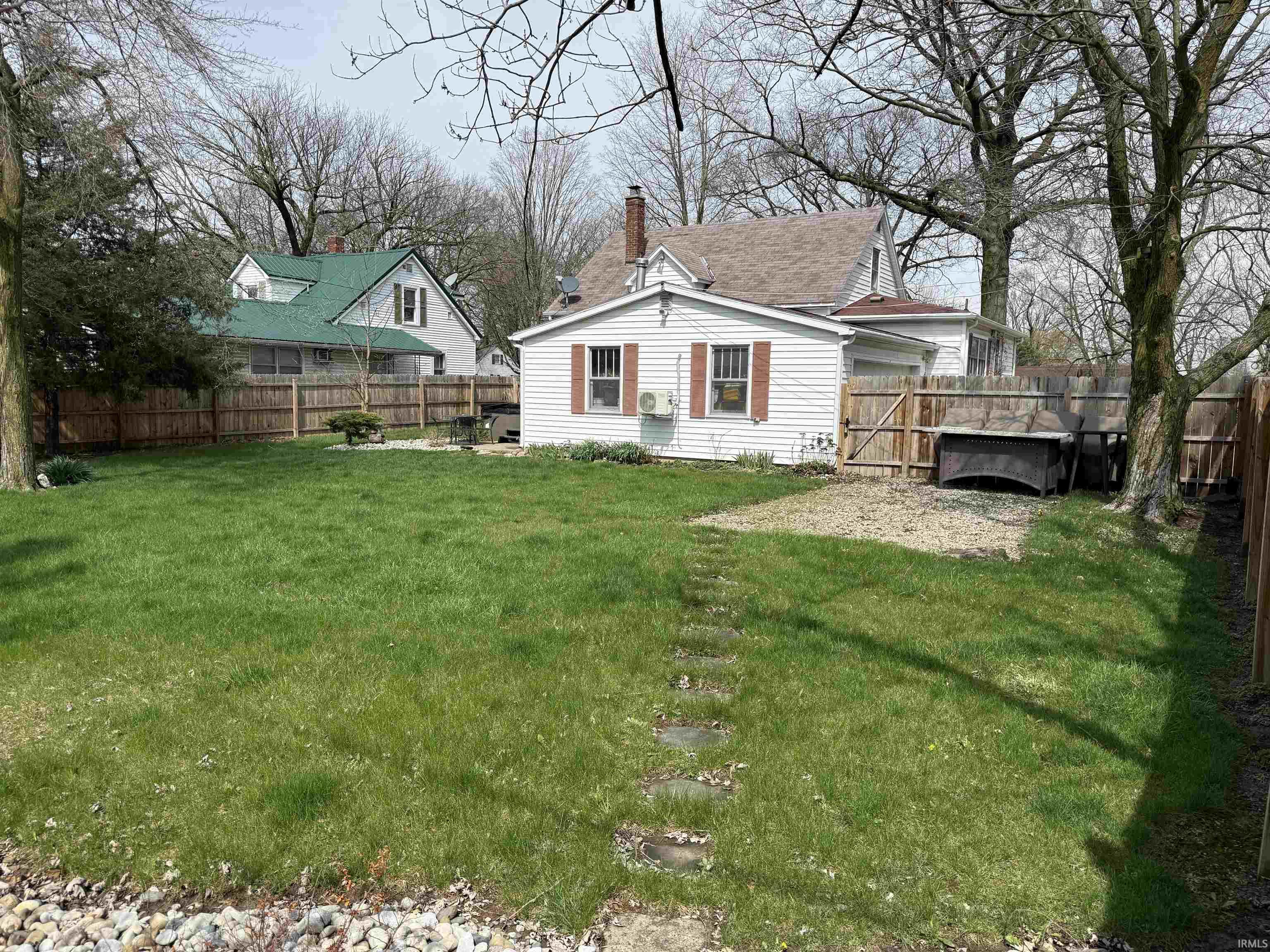 Rear view of property with a chimney and a fenced backyard