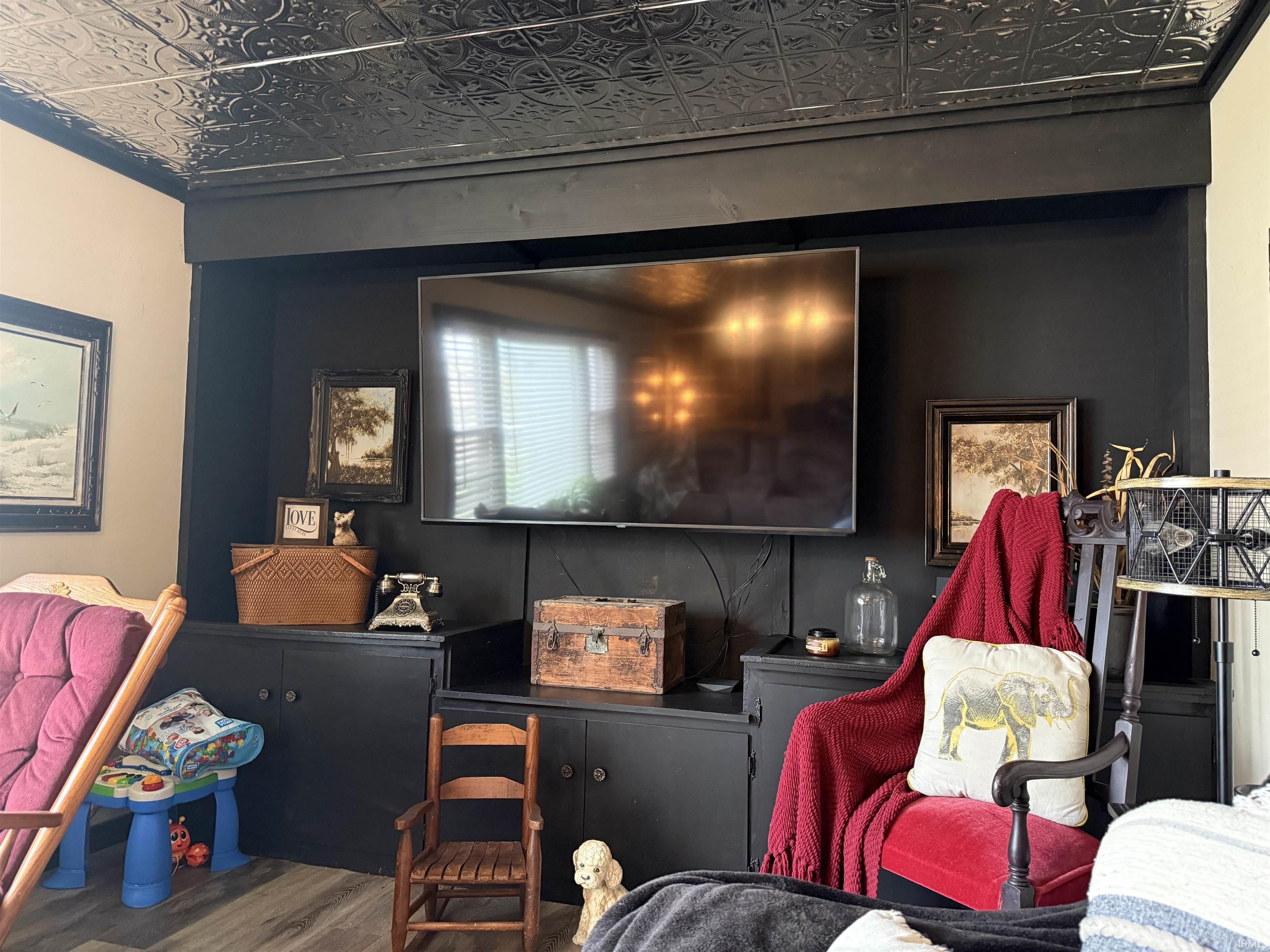 Living area featuring an ornate ceiling and wood finished floors