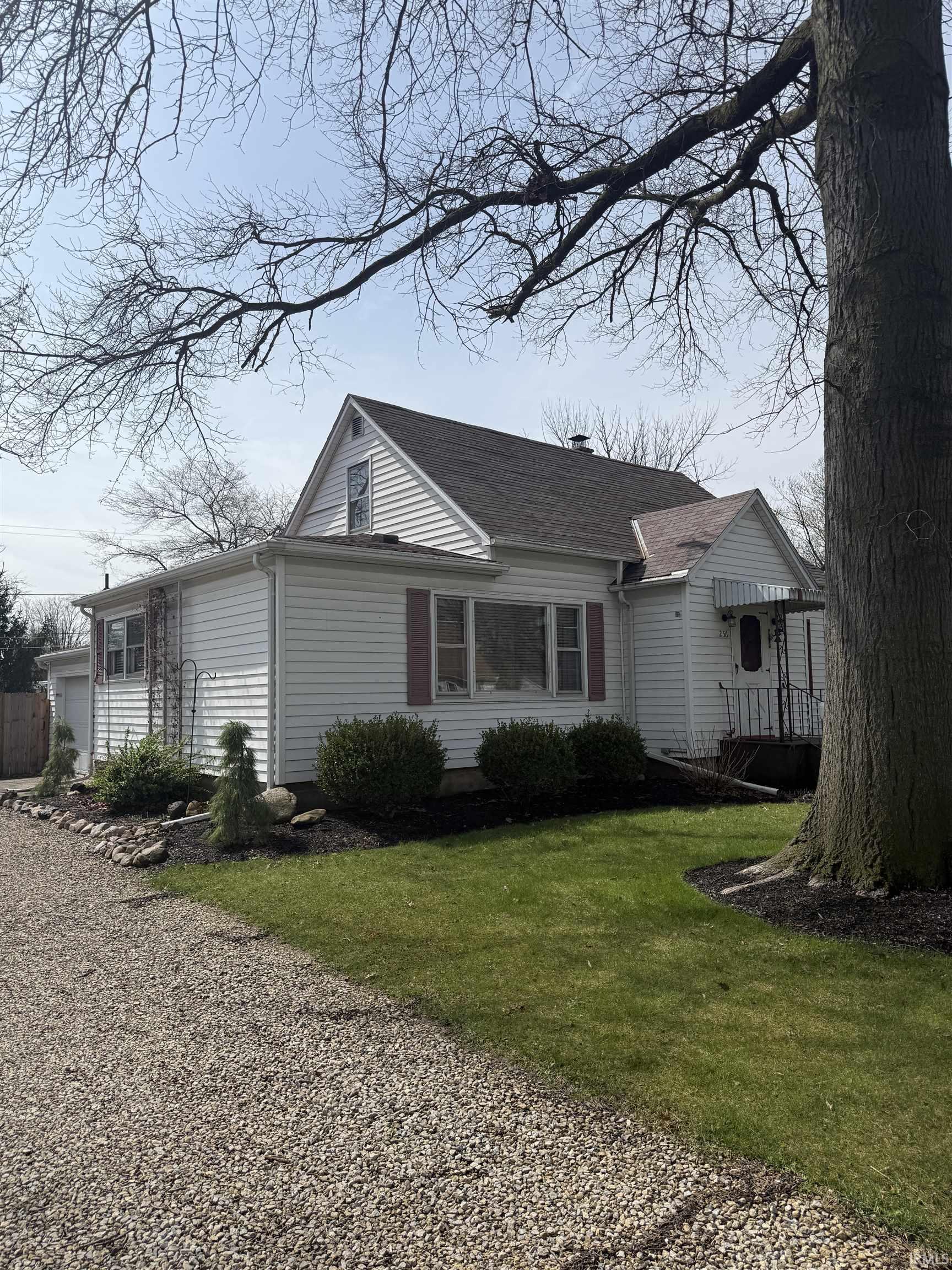 View of front of property featuring a front yard and a garage