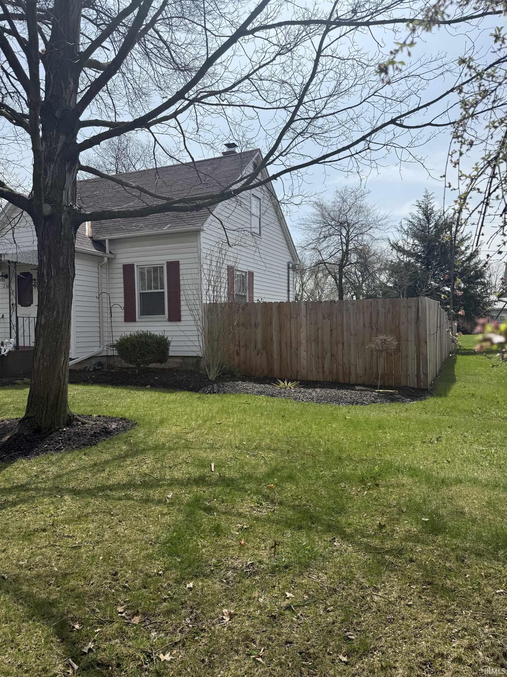 View of property exterior with a chimney and a shingled roof