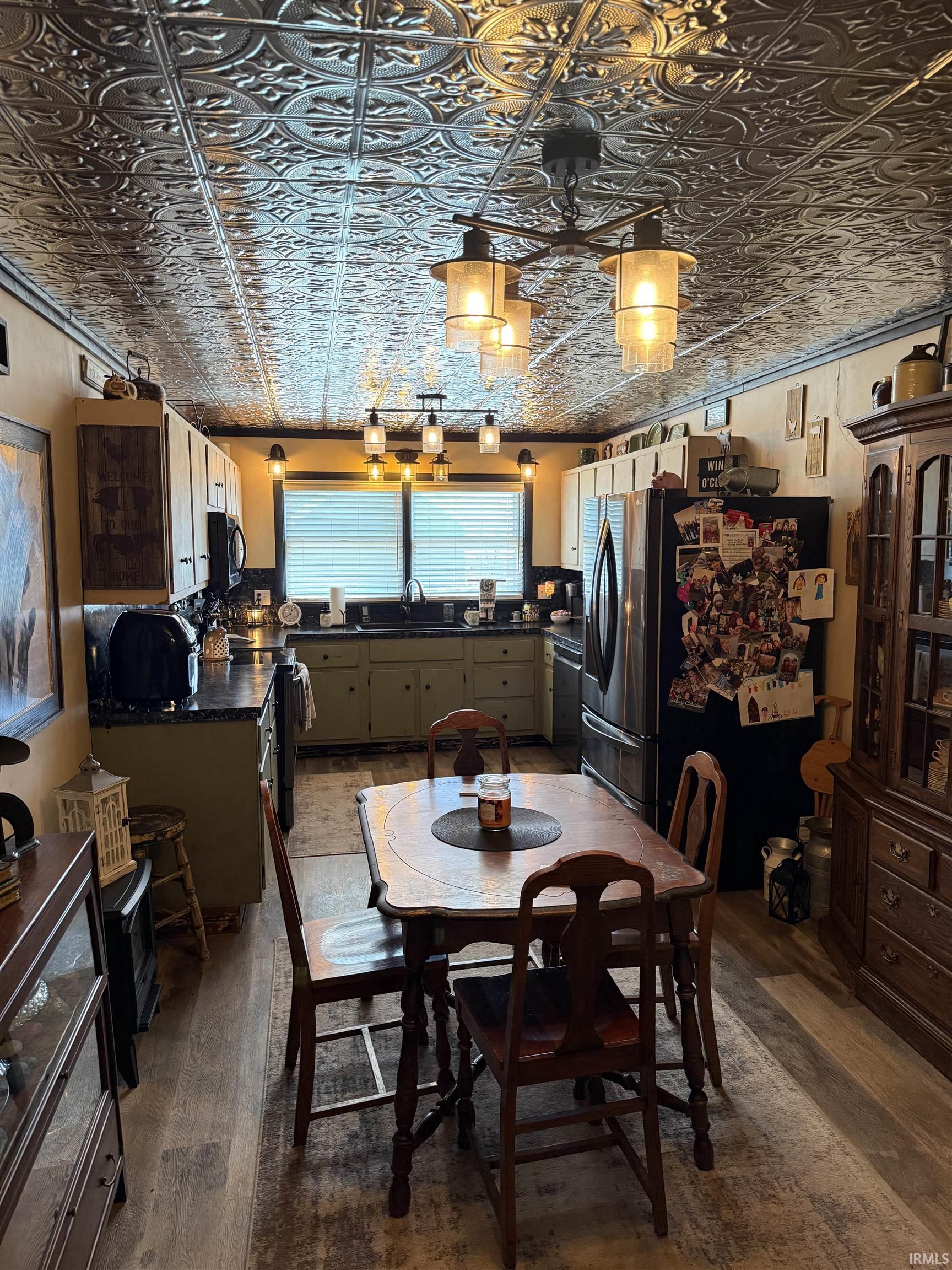 Dining space with dark wood-style flooring and an ornate ceiling