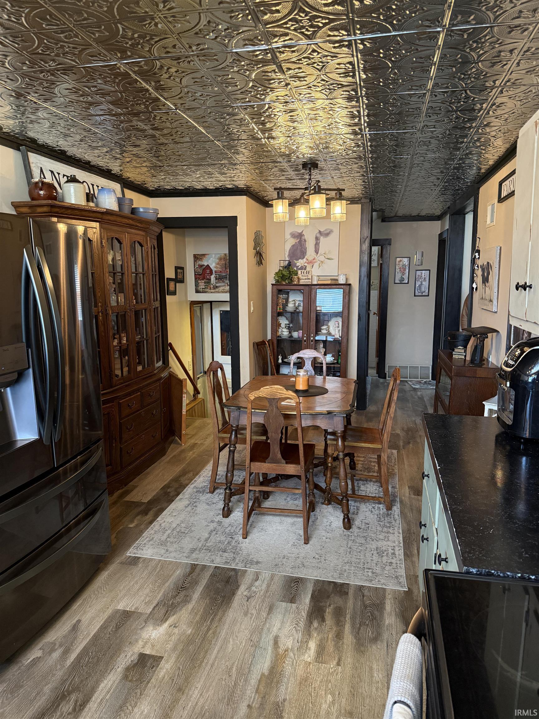 Dining space featuring an ornate ceiling and light wood finished floors