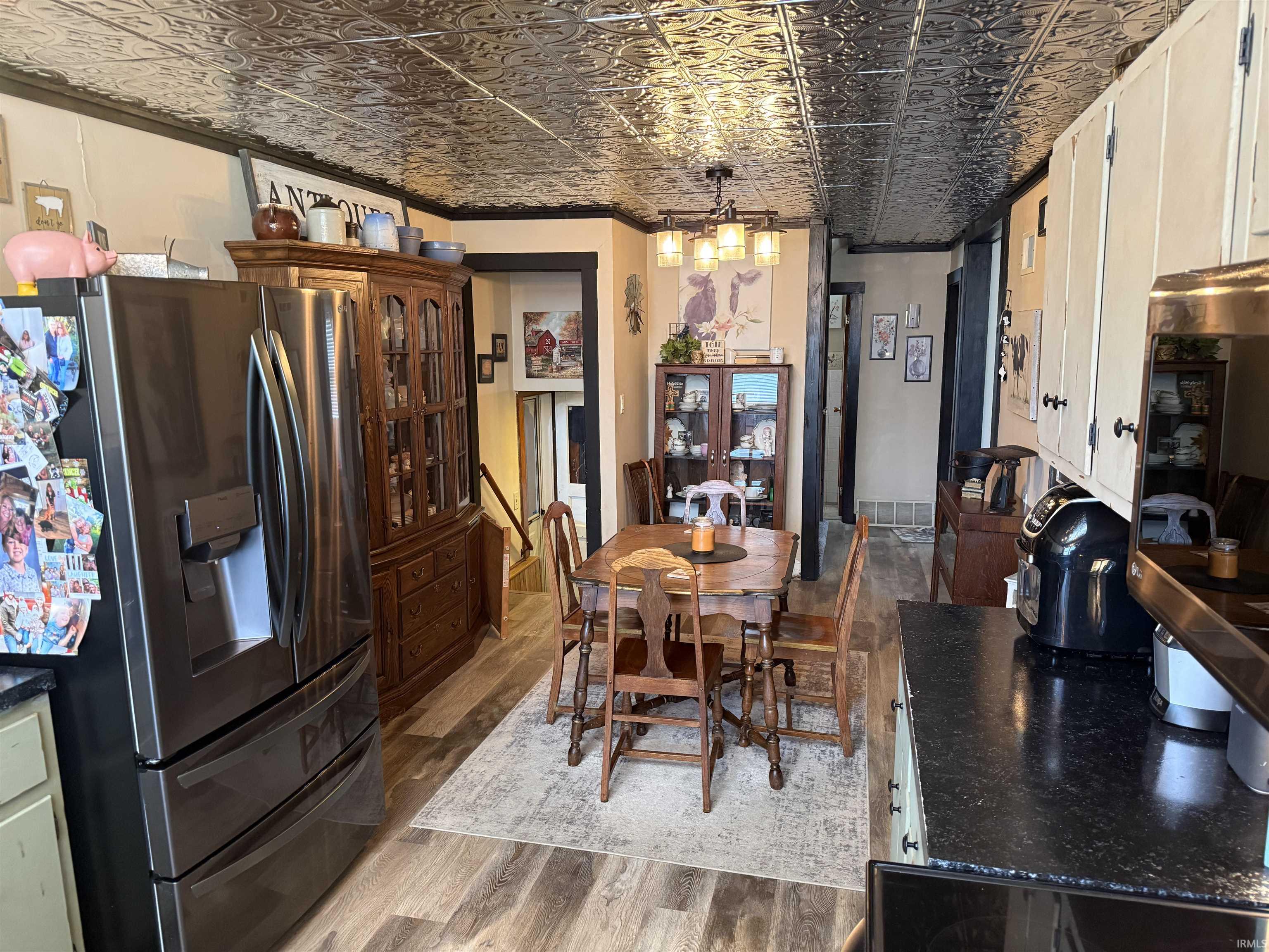 Dining area with an ornate ceiling and light wood-style floors