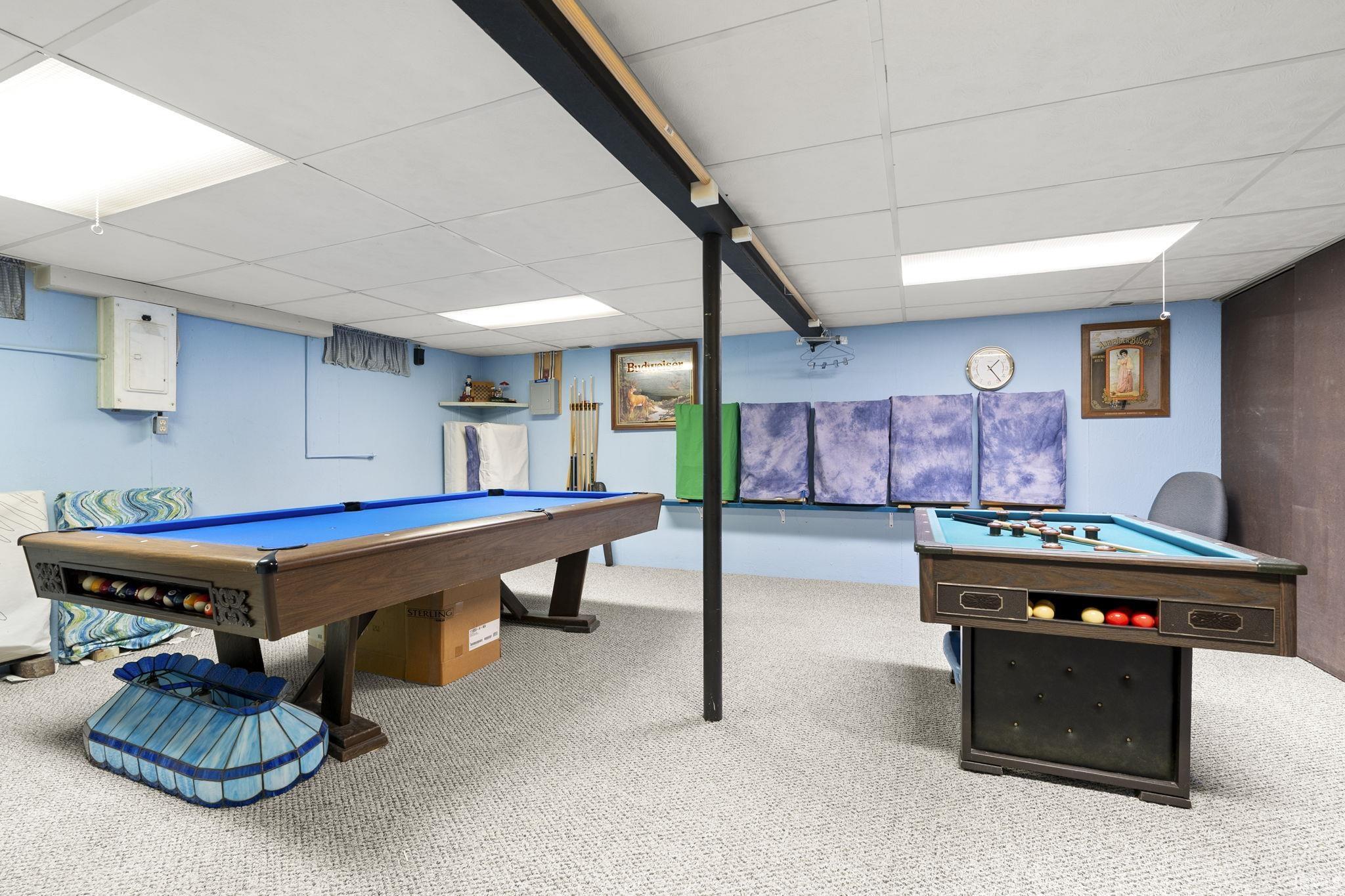 Recreation room with pool table, a drop ceiling, carpet floors, and electric panel