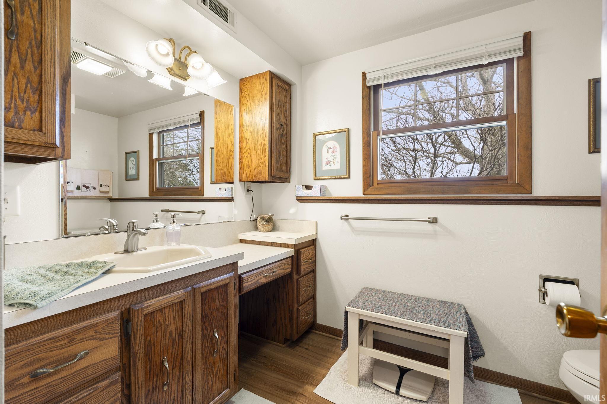 Bathroom featuring vanity and light wood-style floors