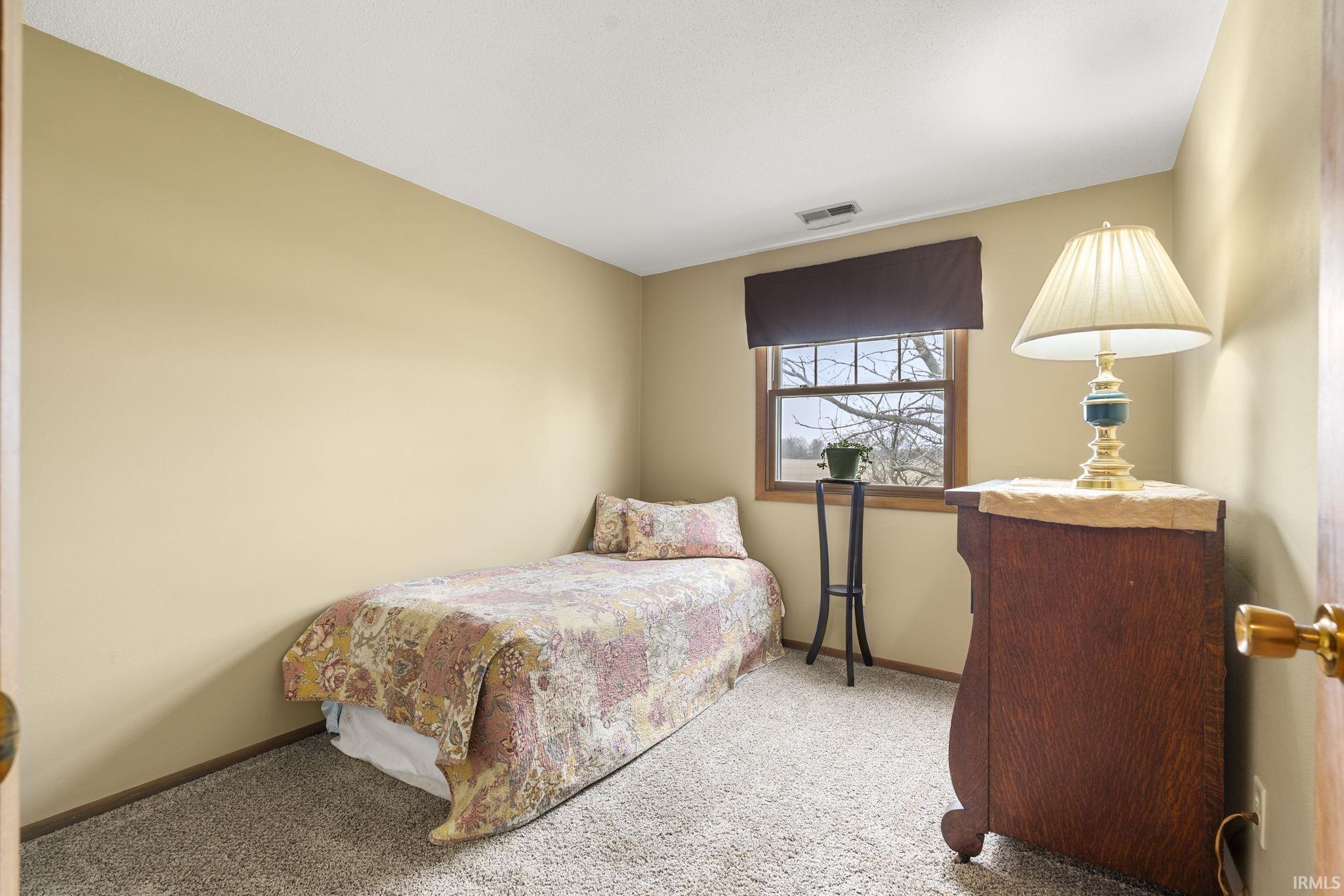 Carpeted bedroom with baseboards