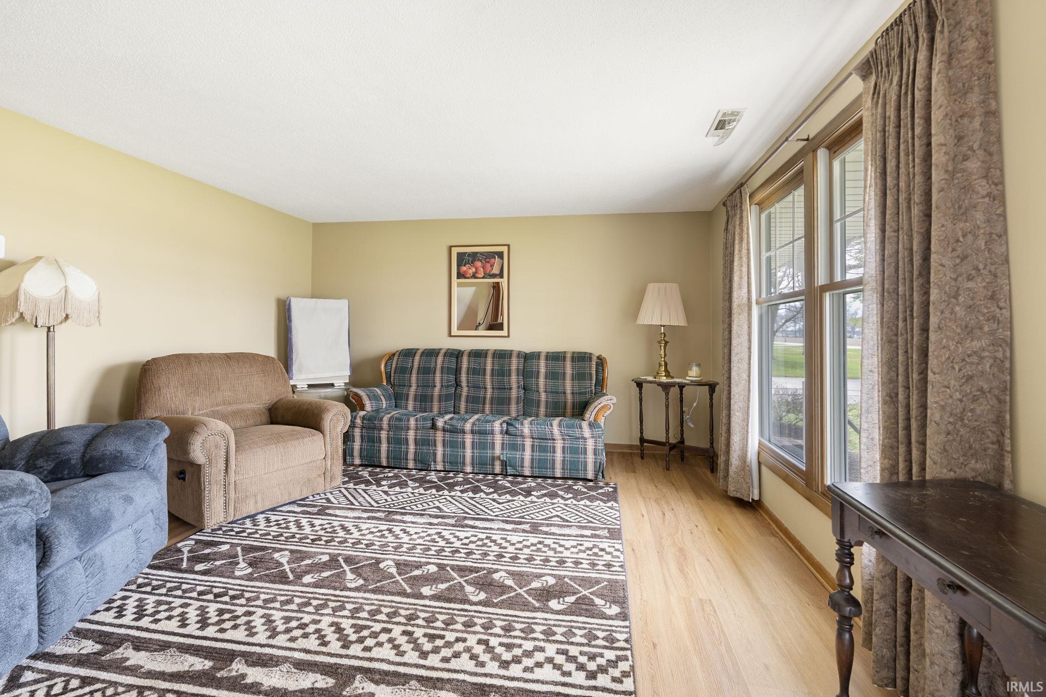 Living area featuring light wood-style floors and baseboards