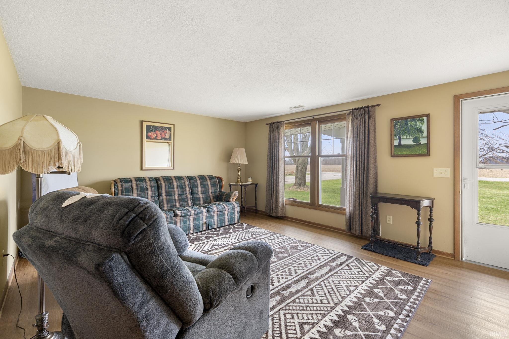 Living room featuring light wood-style flooring and baseboards