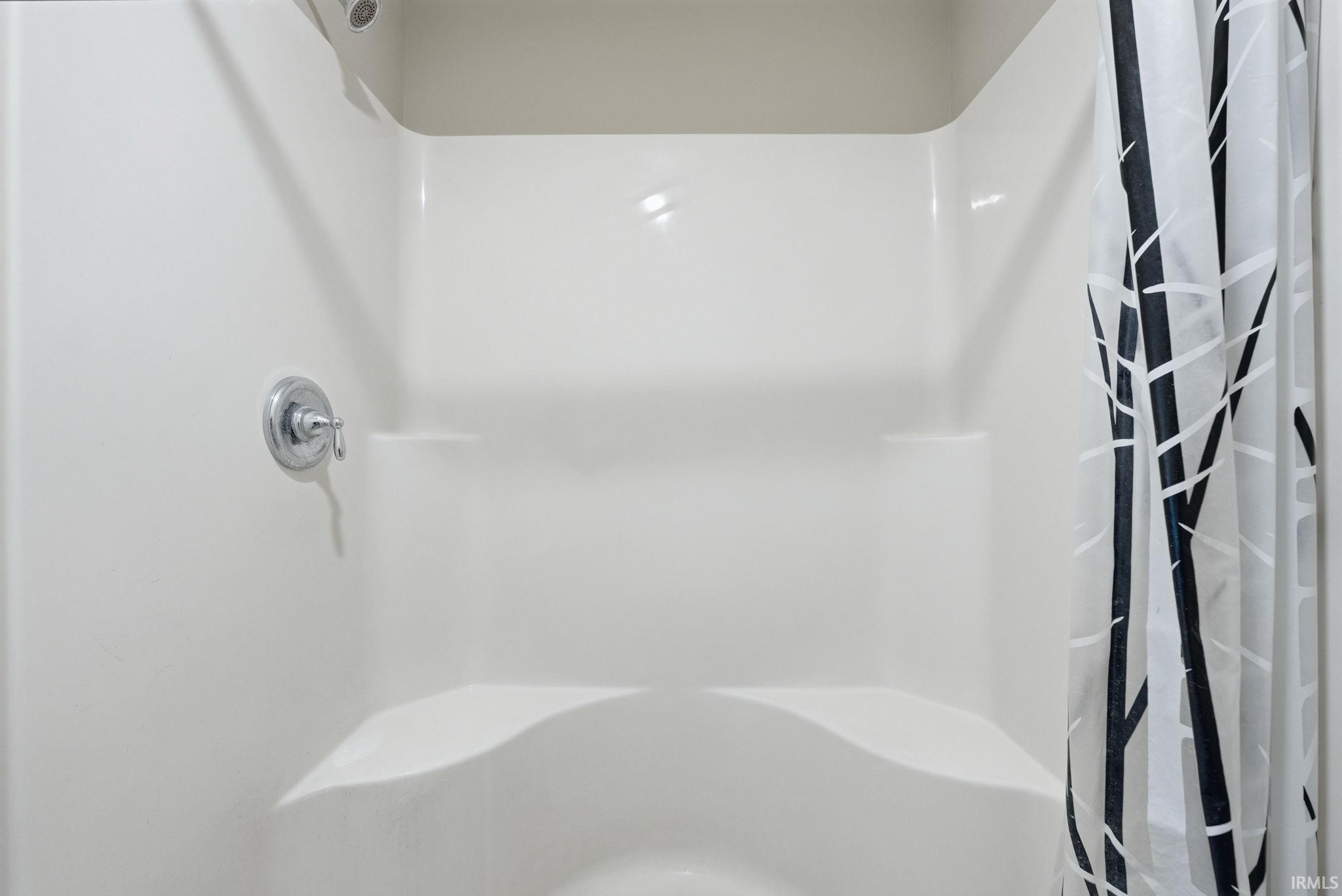 Full bathroom with curtained shower