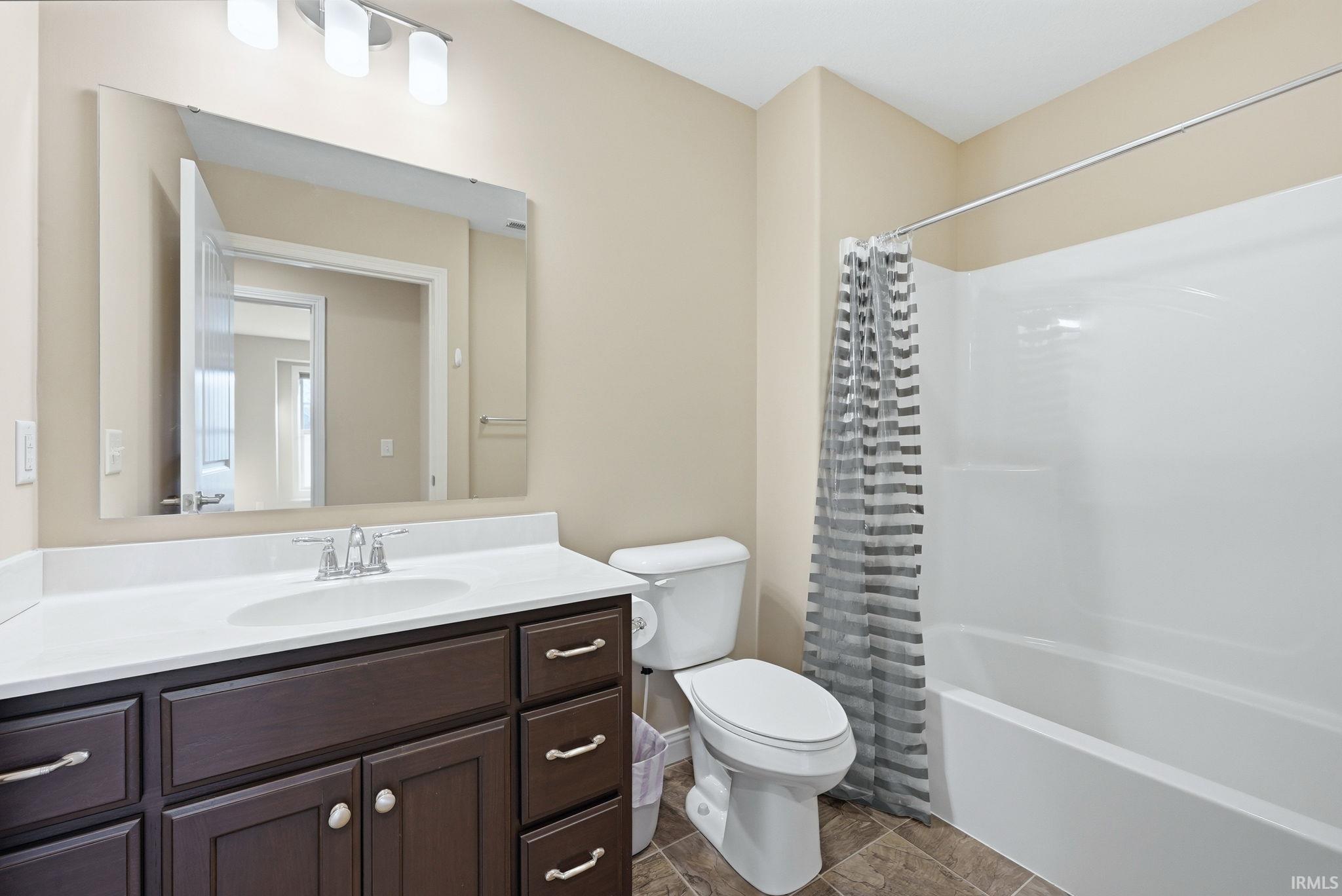 Full bathroom featuring vanity and shower / bath combo with shower curtain