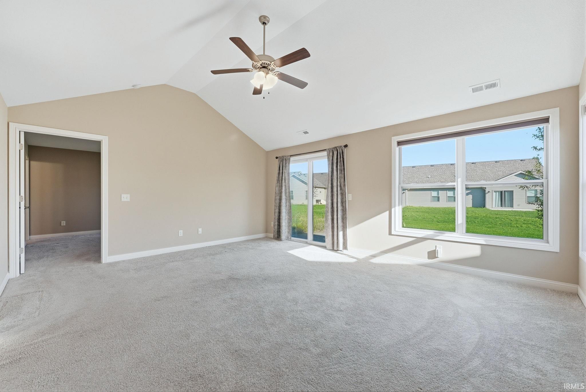 Unfurnished room featuring a ceiling fan and light colored carpet