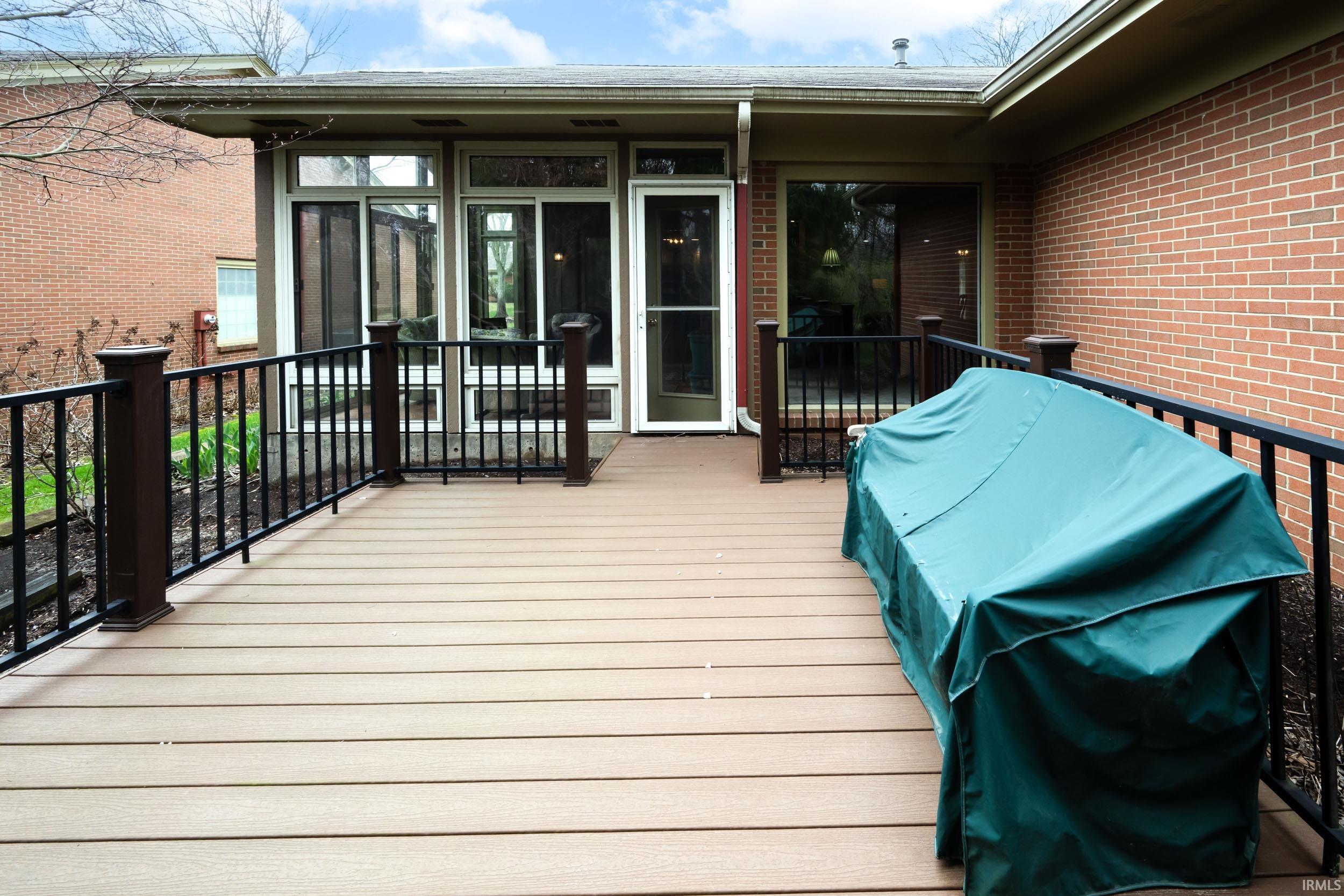 Wooden terrace featuring area for grilling