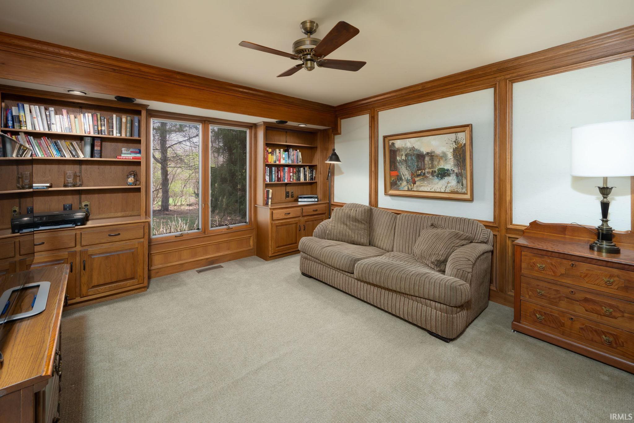 Sitting room featuring ceiling fan and light colored carpet