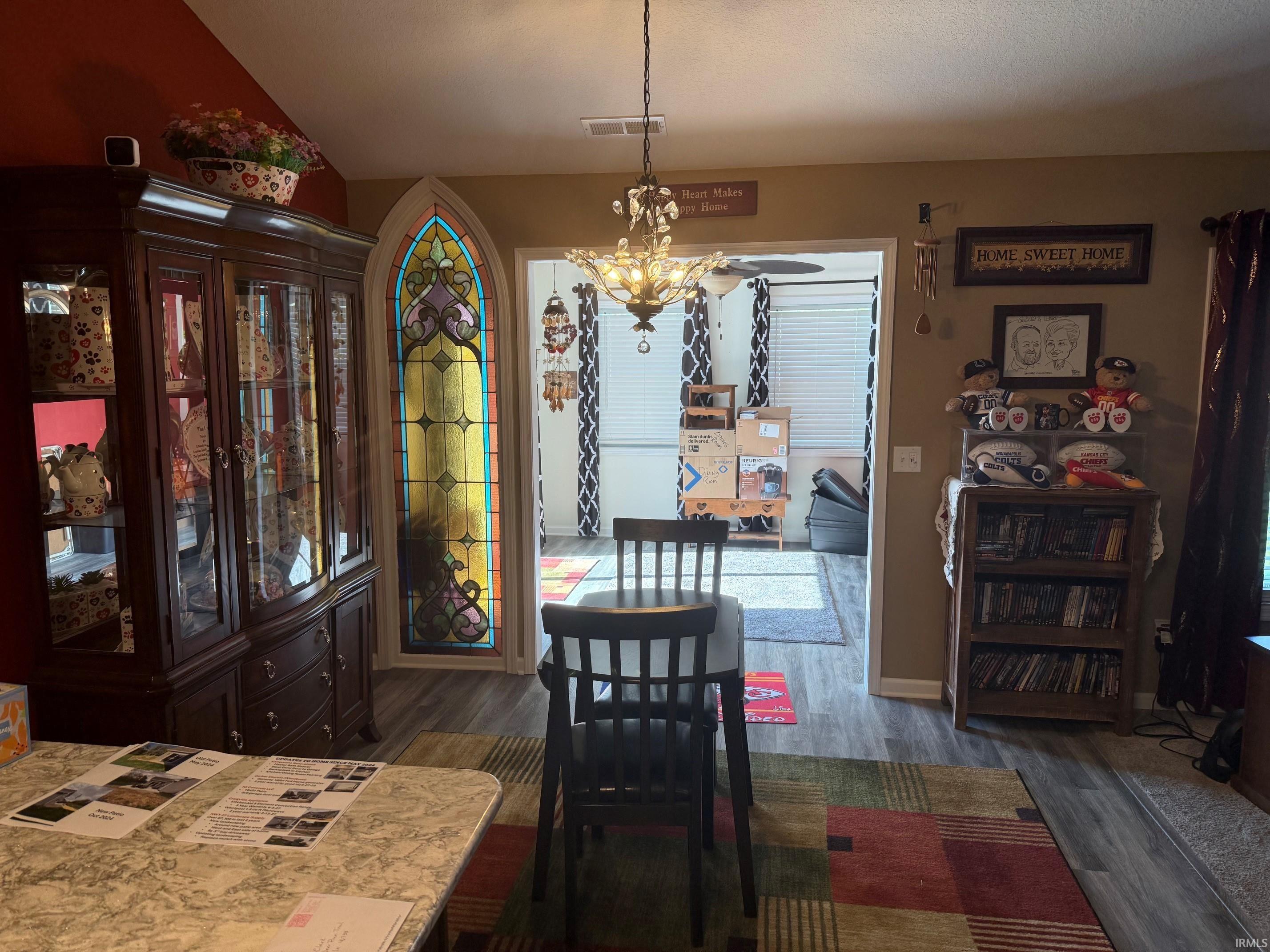 Dining room featuring hanging lights and dark wood finished floors