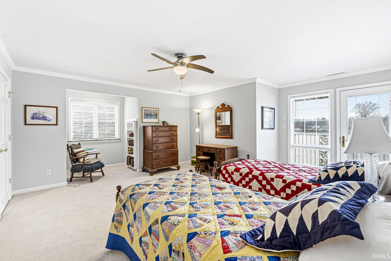 Bedroom featuring ornamental molding, carpet floors, and ceiling fan