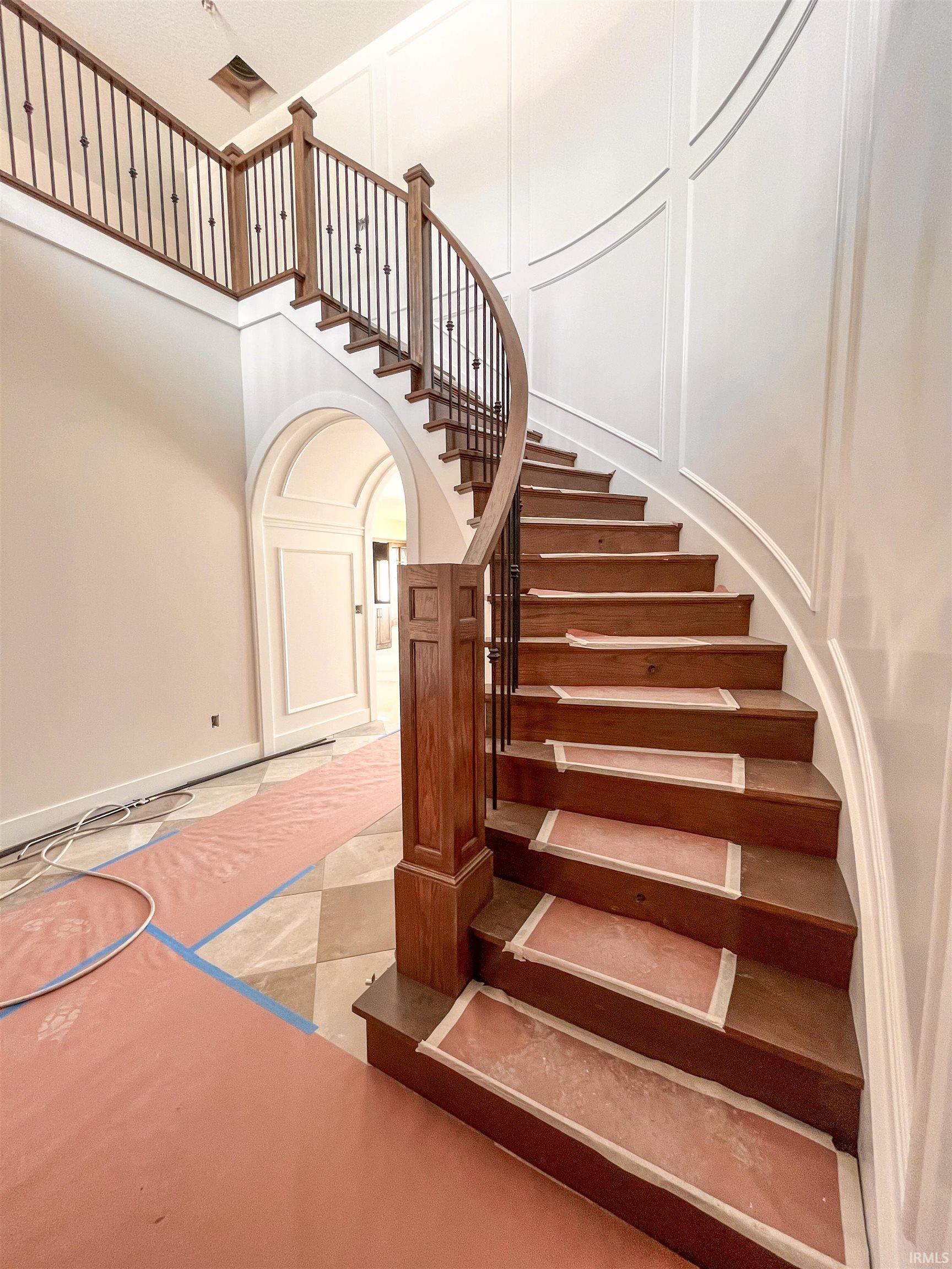 Stairway with arched walkways and a high ceiling