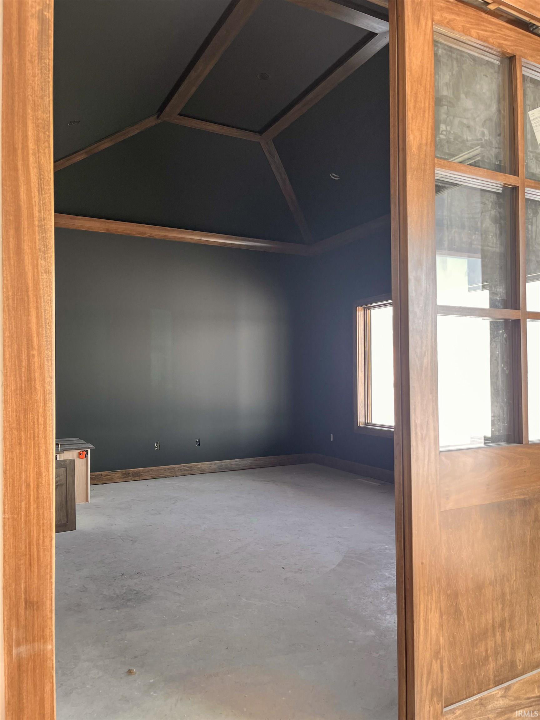 Unfurnished room featuring concrete flooring