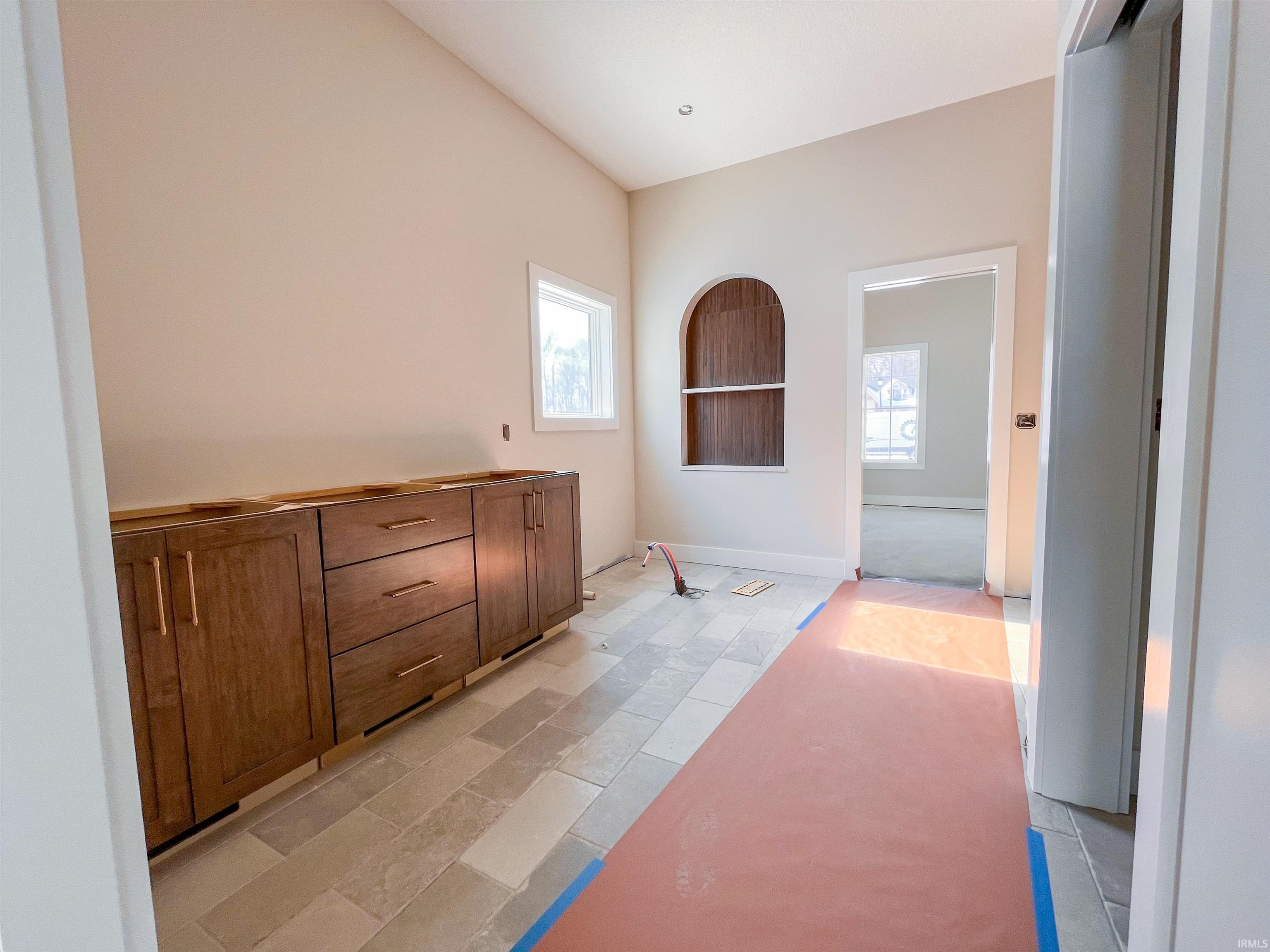 Full bath featuring vaulted ceiling and vanity