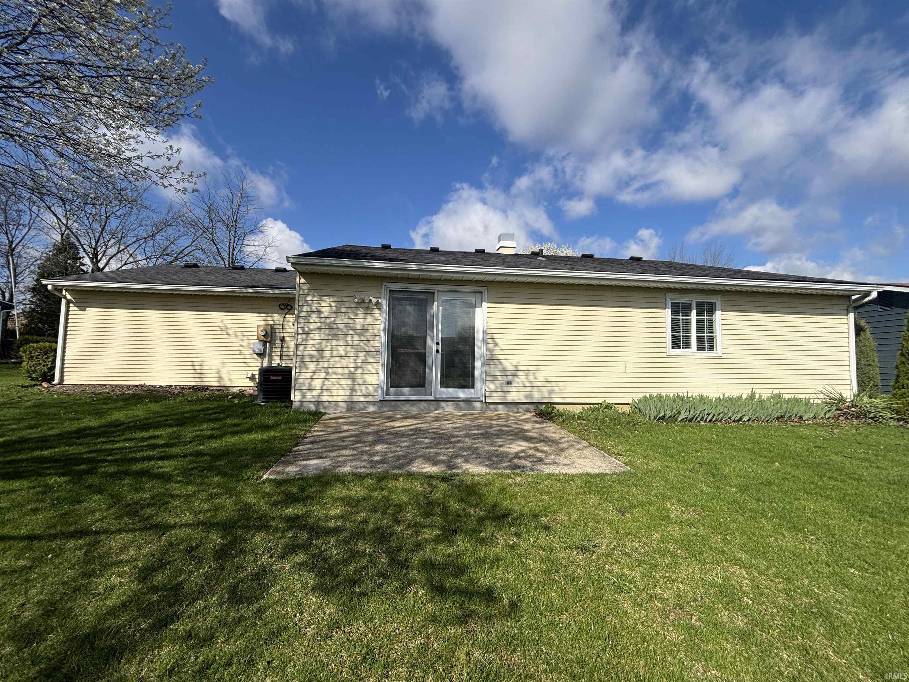 Back of property with a patio area and a yard