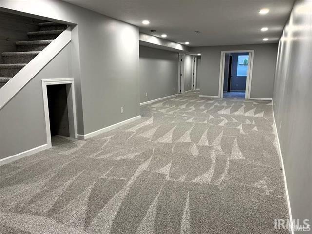 Finished basement featuring recessed lighting and light colored carpet