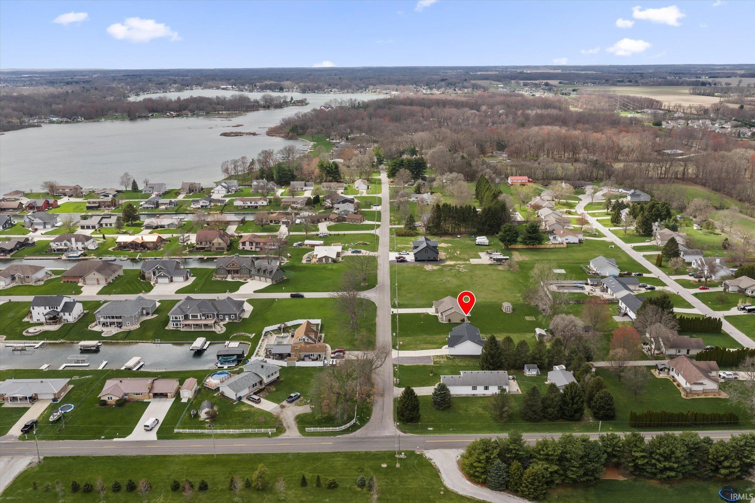 Aerial perspective of suburban area featuring a large body of water