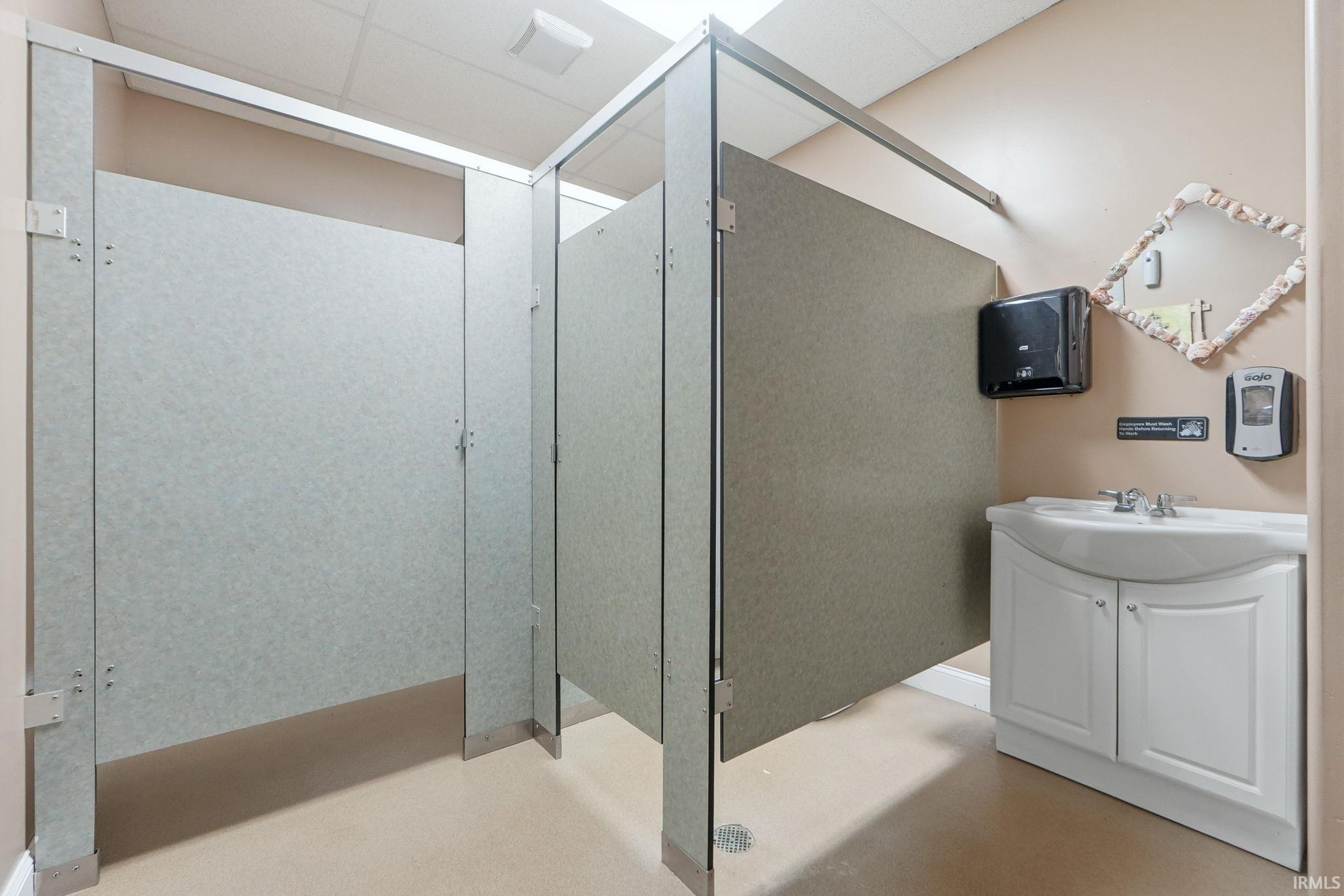 Bathroom with finished concrete flooring and vanity