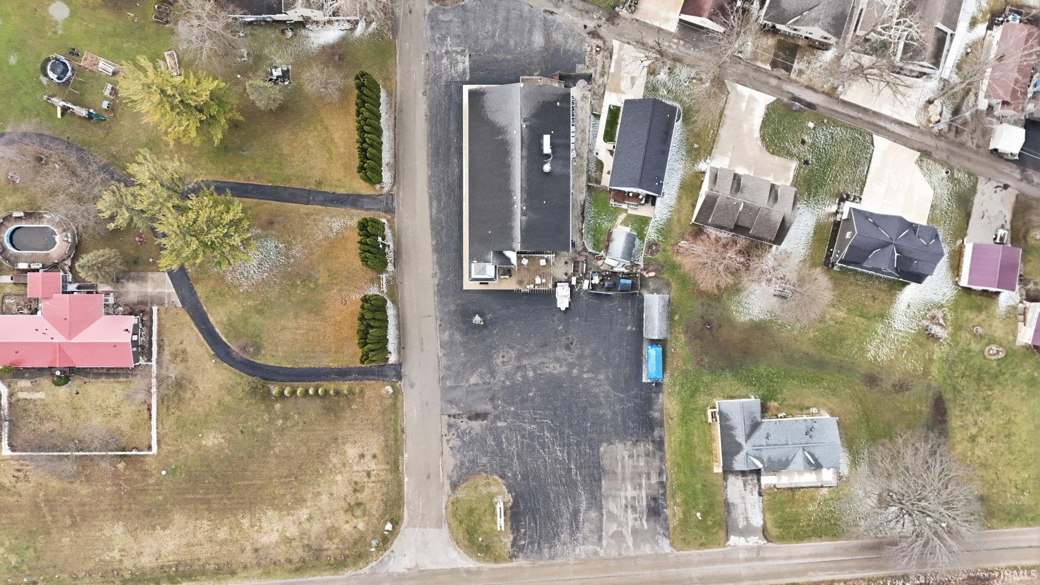 Aerial view of property's location with nearby suburban area