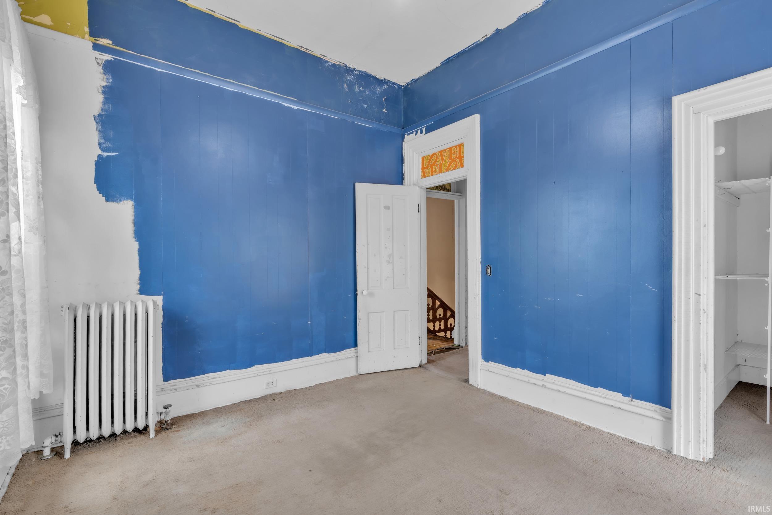 Unfurnished room featuring radiator heating unit