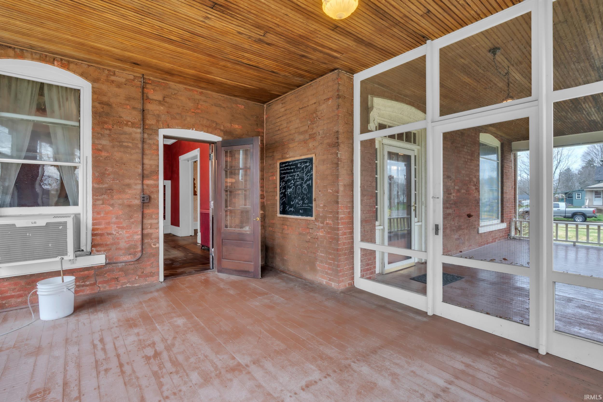 Unfurnished sunroom with cooling unit