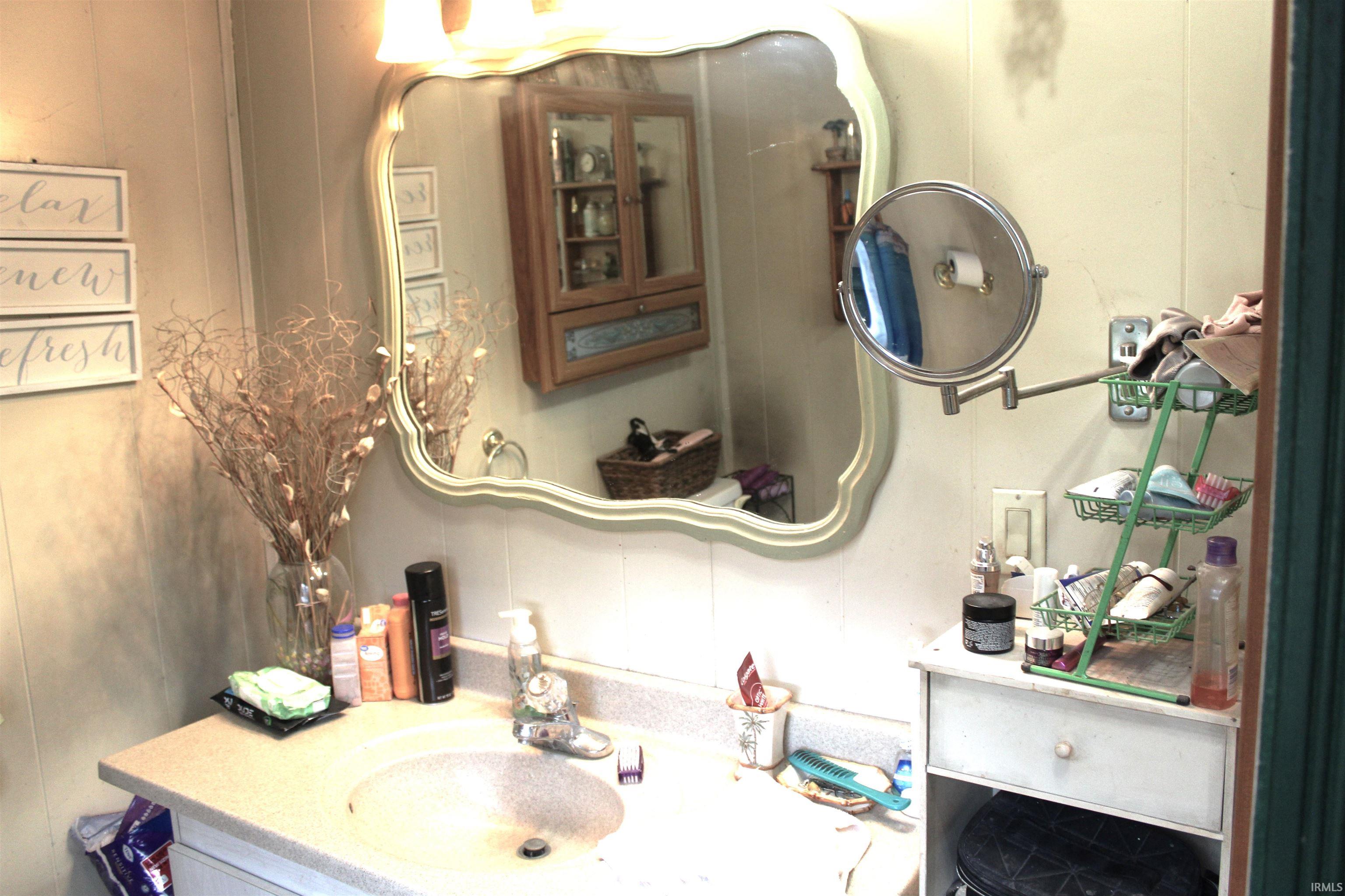 Bathroom featuring vanity and a decorative wall
