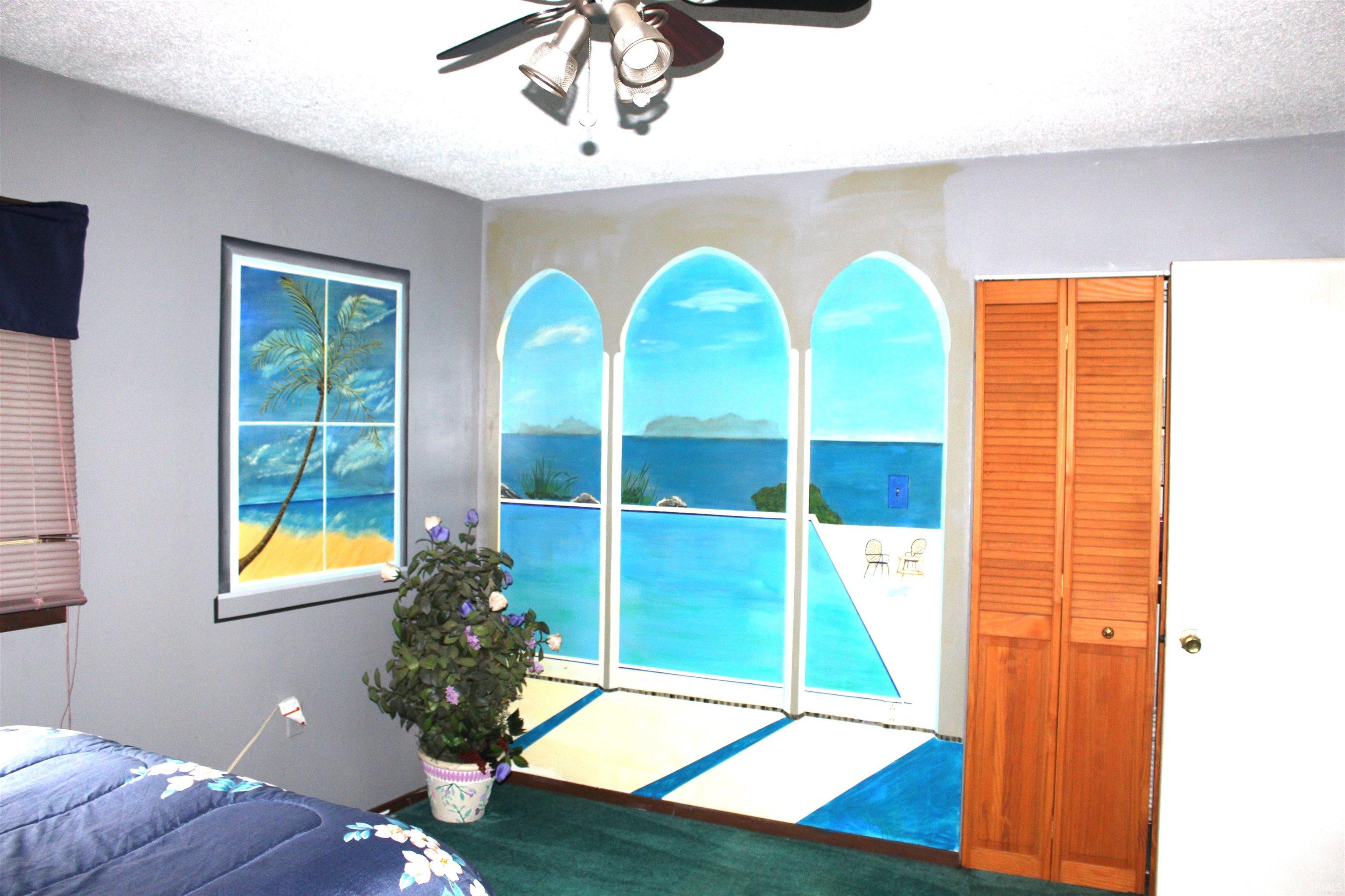 Unfurnished bedroom with a textured ceiling, ceiling fan, and access to exterior