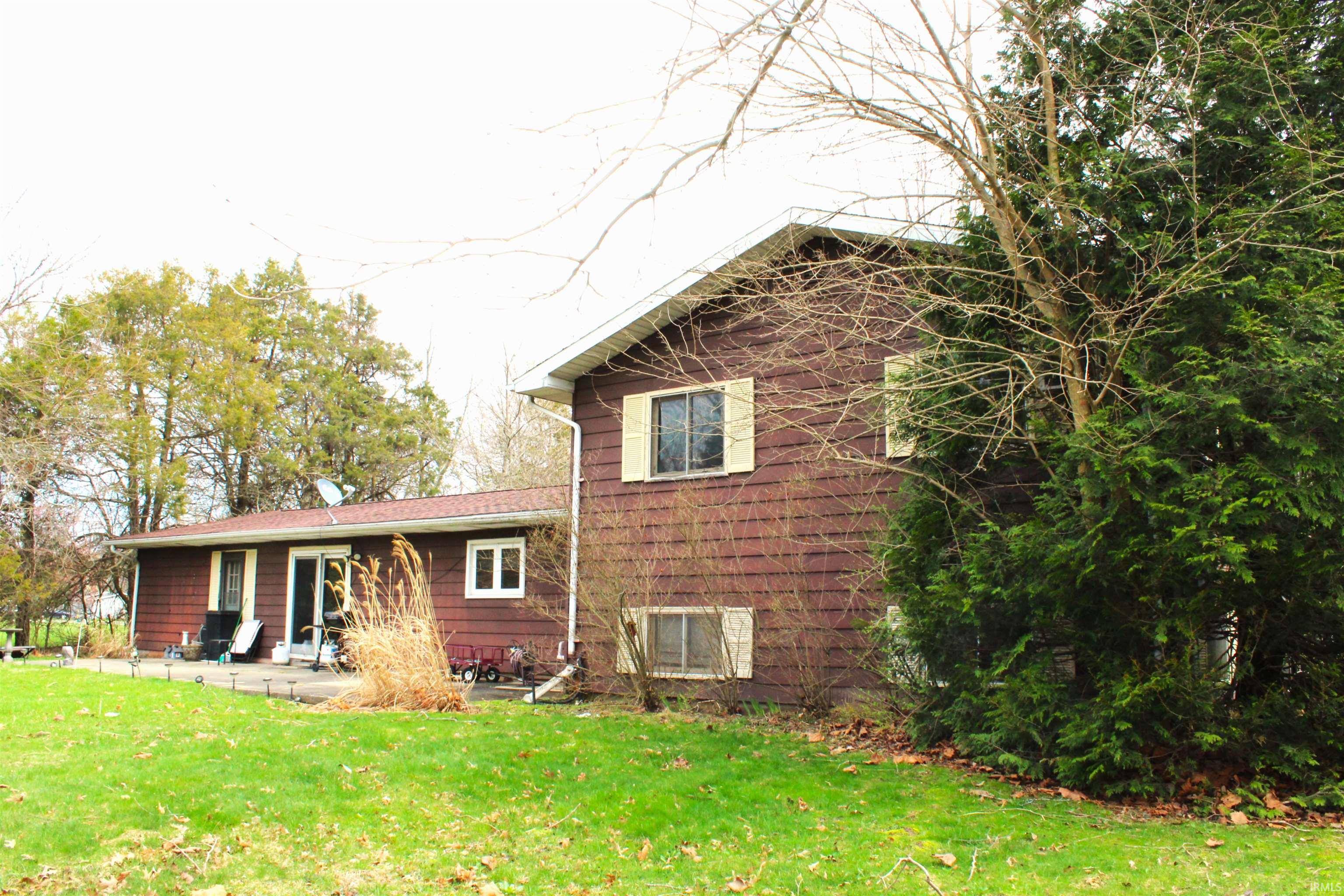 Rear view of property featuring a yard and a patio area