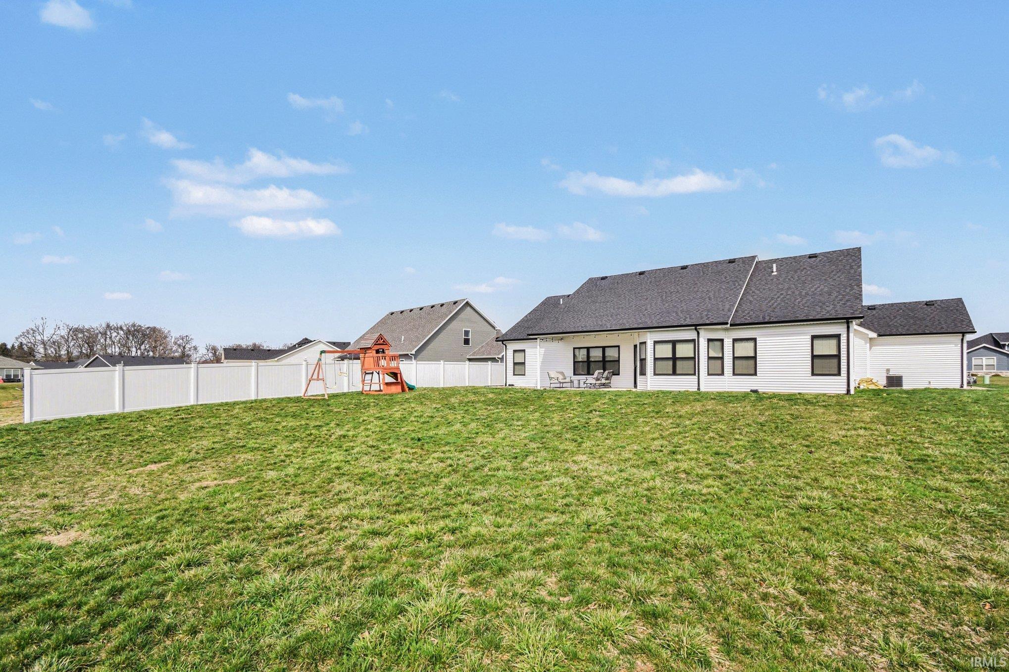 Rear view of property featuring a patio and a fenced backyard