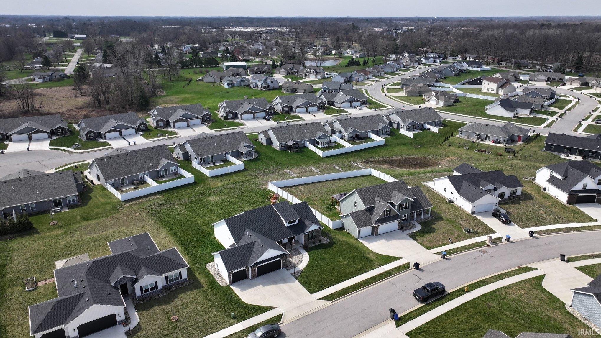 Aerial view of property's location with nearby suburban area