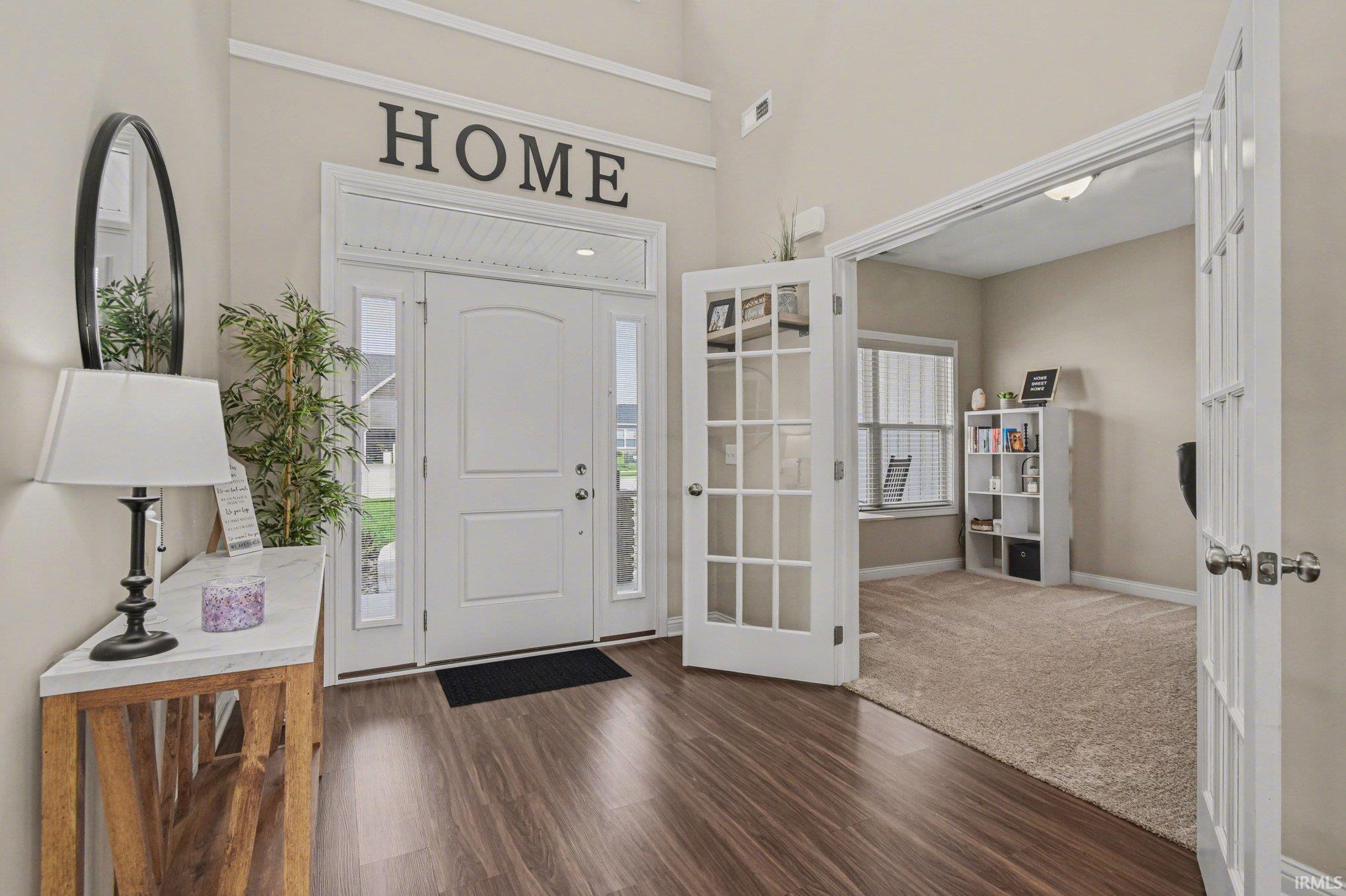 Foyer featuring dark wood finished floors and a high ceiling