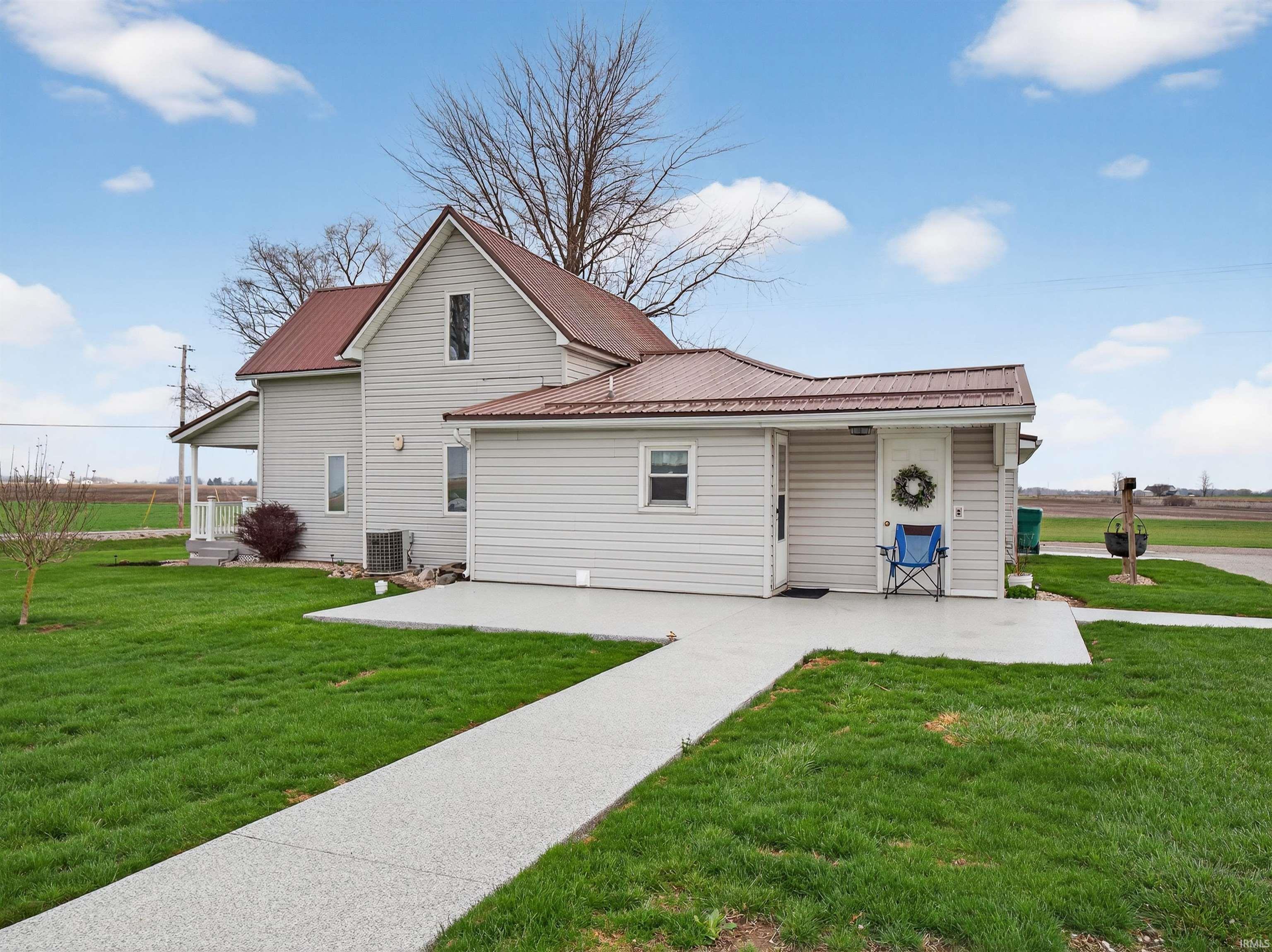 View of side of home featuring a yard and a cooling unit