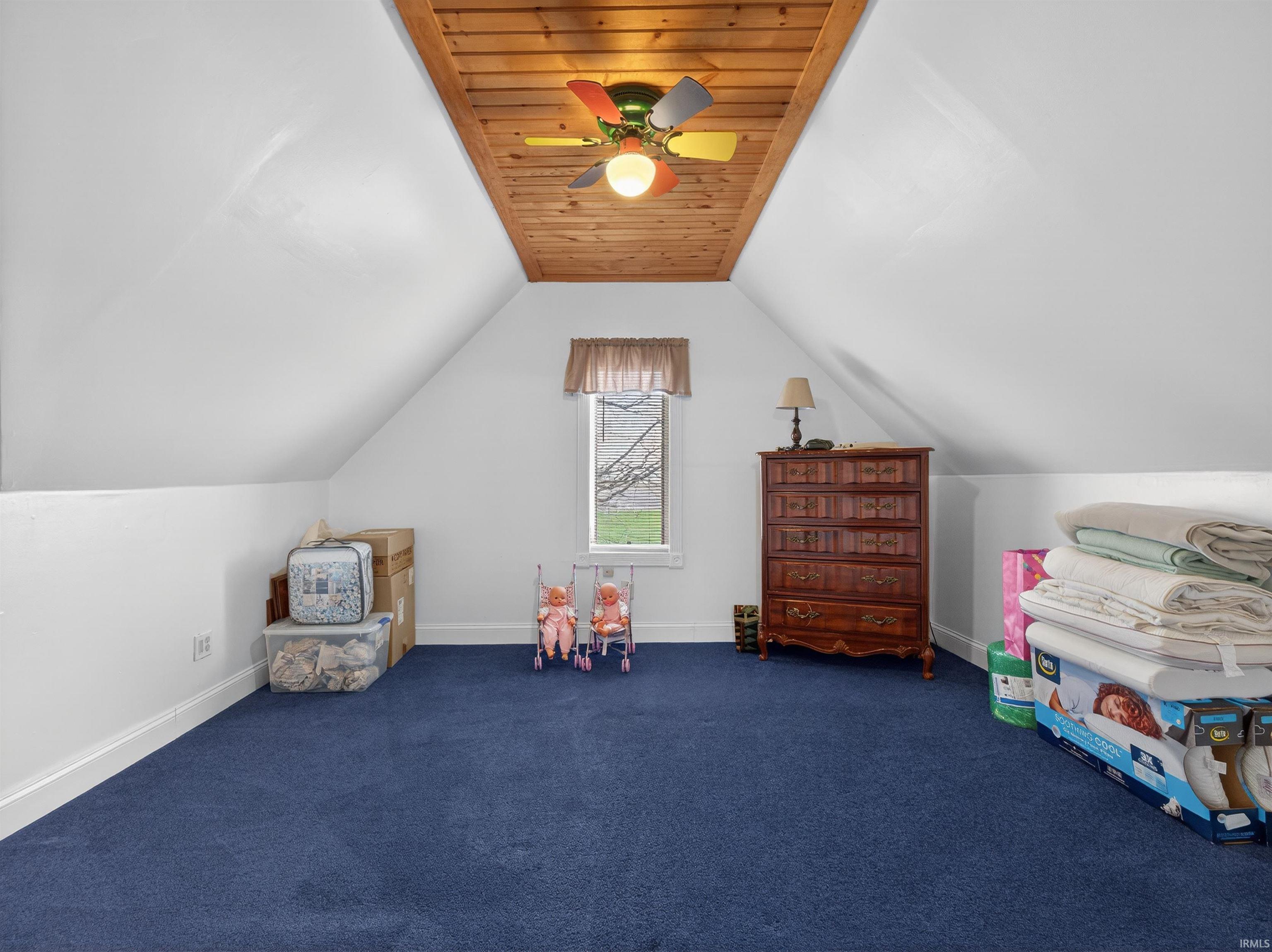 Playroom featuring carpet floors, ceiling fan, and wood ceiling