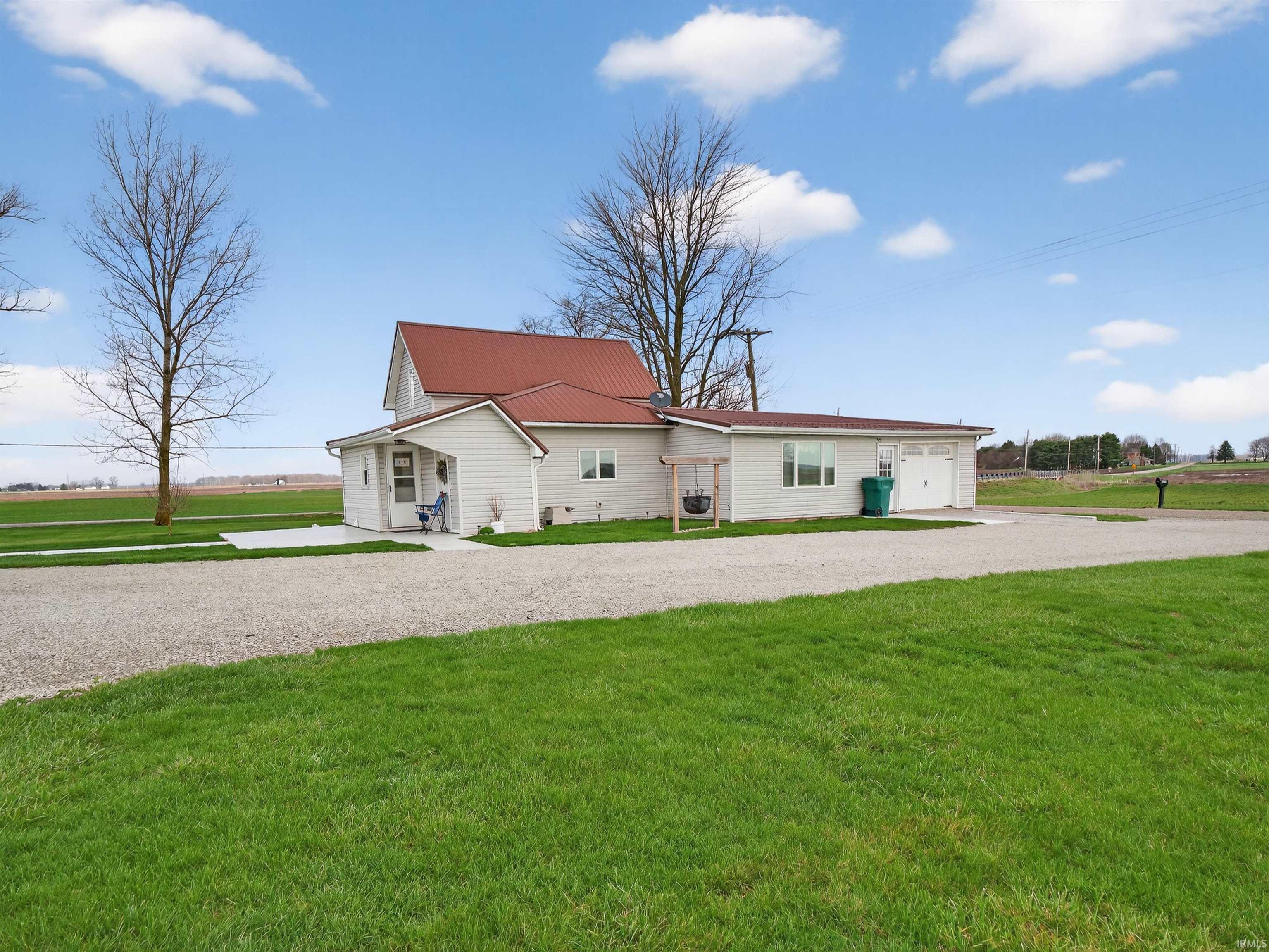 View of front of home featuring a front lawn, driveway, and a garage