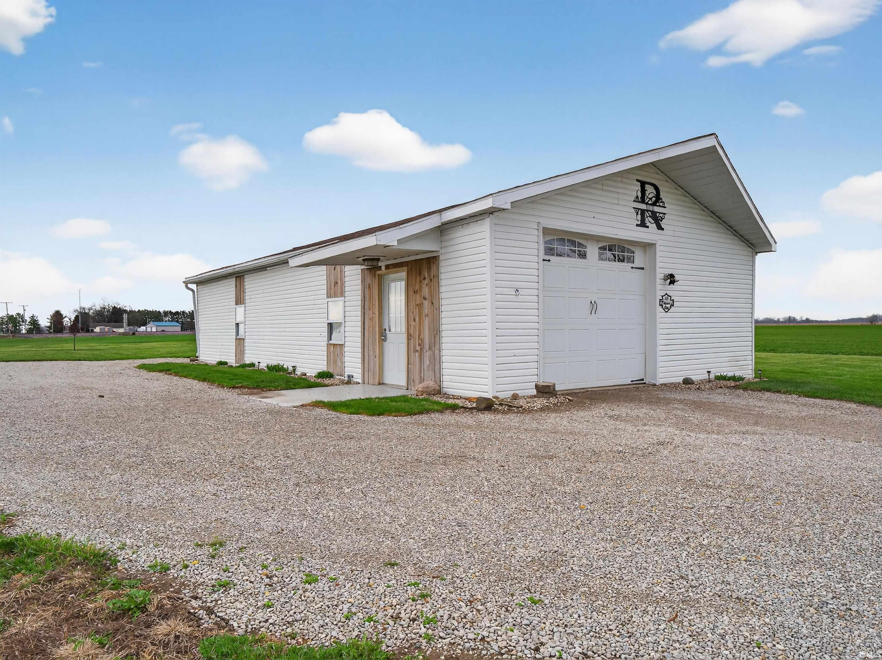 Garage with gravel driveway