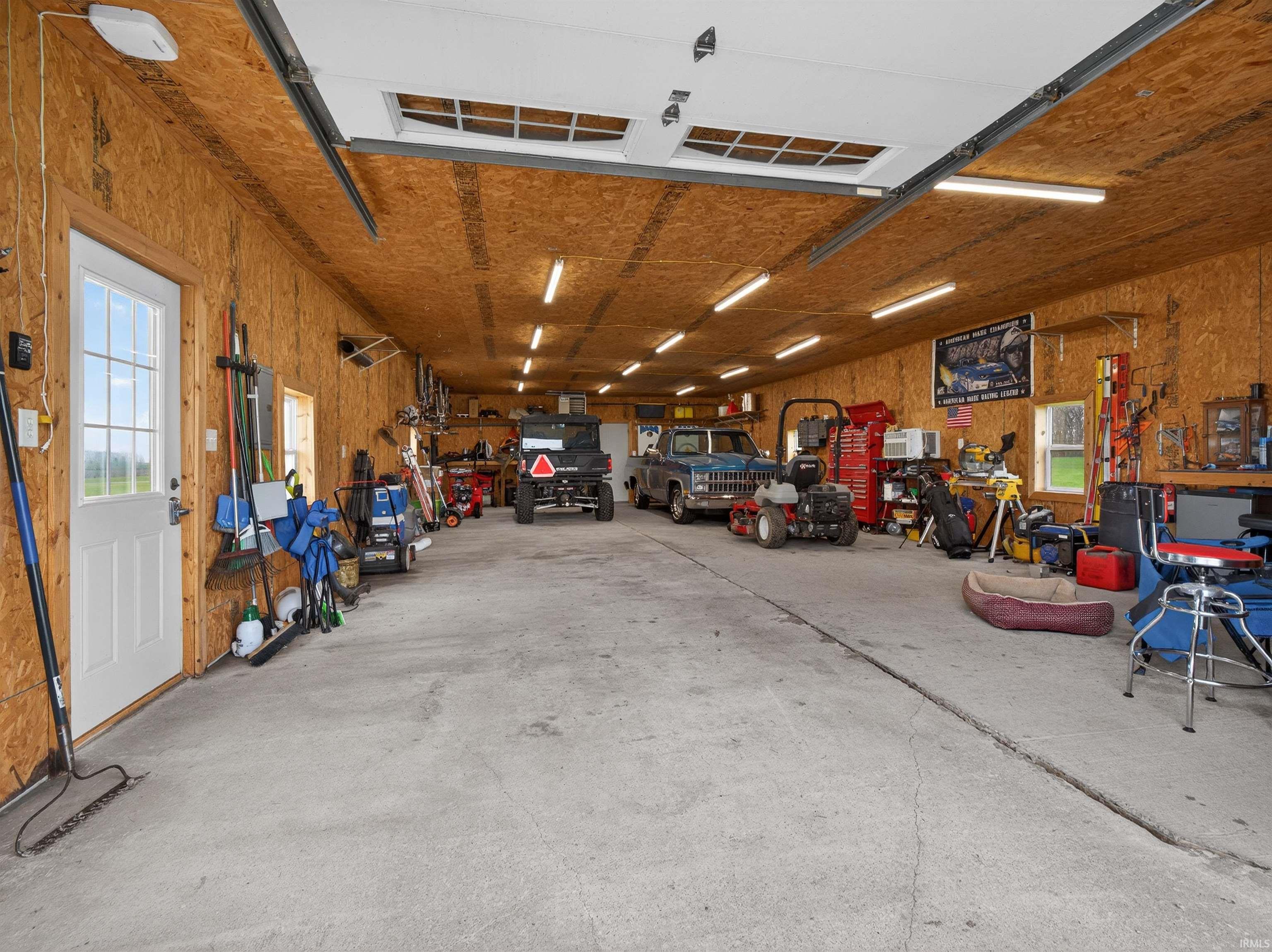 Garage featuring a workshop area and a heating unit
