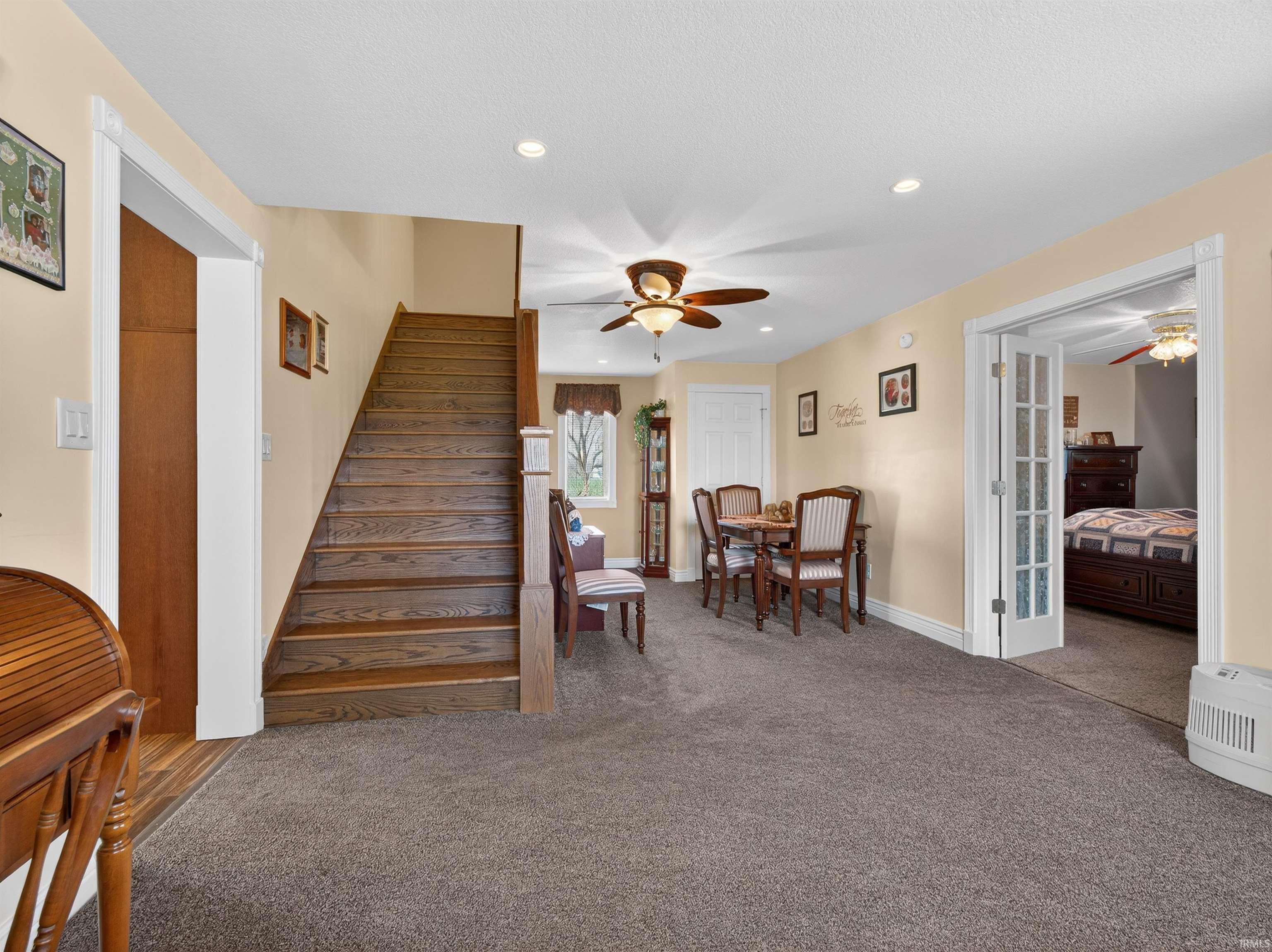 Stairway featuring carpet floors, recessed lighting, and a ceiling fan