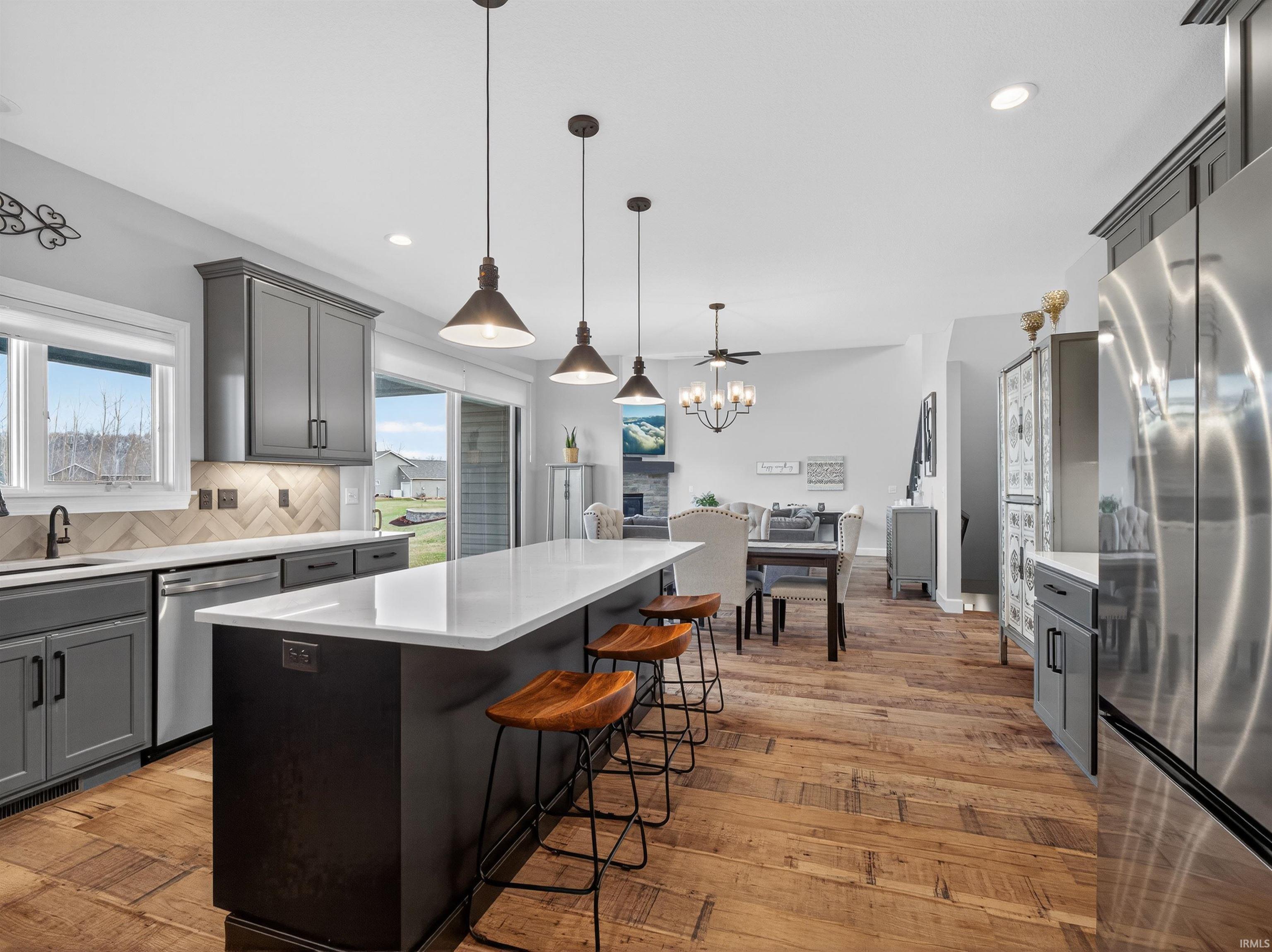Kitchen featuring gray cabinets, stainless steel appliances, and a center island