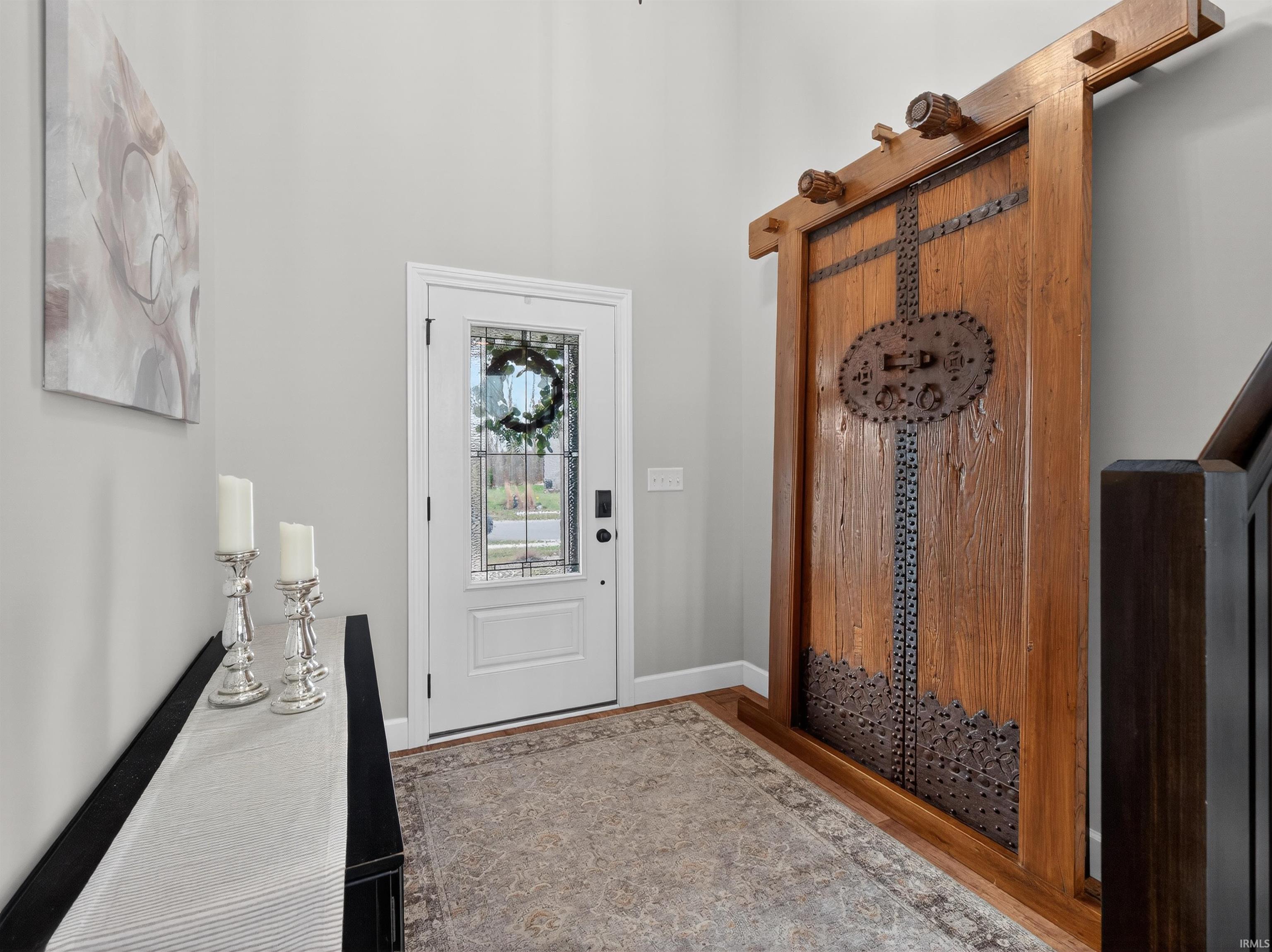 Entrance foyer with baseboards and light wood-style floors
