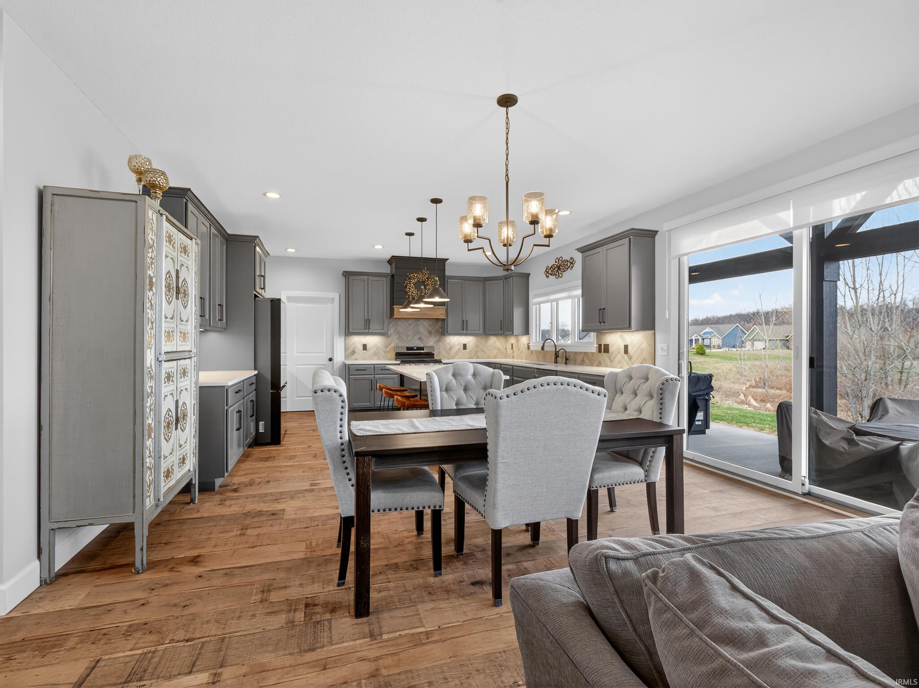 Dining room with suspended lighting and light wood-style flooring