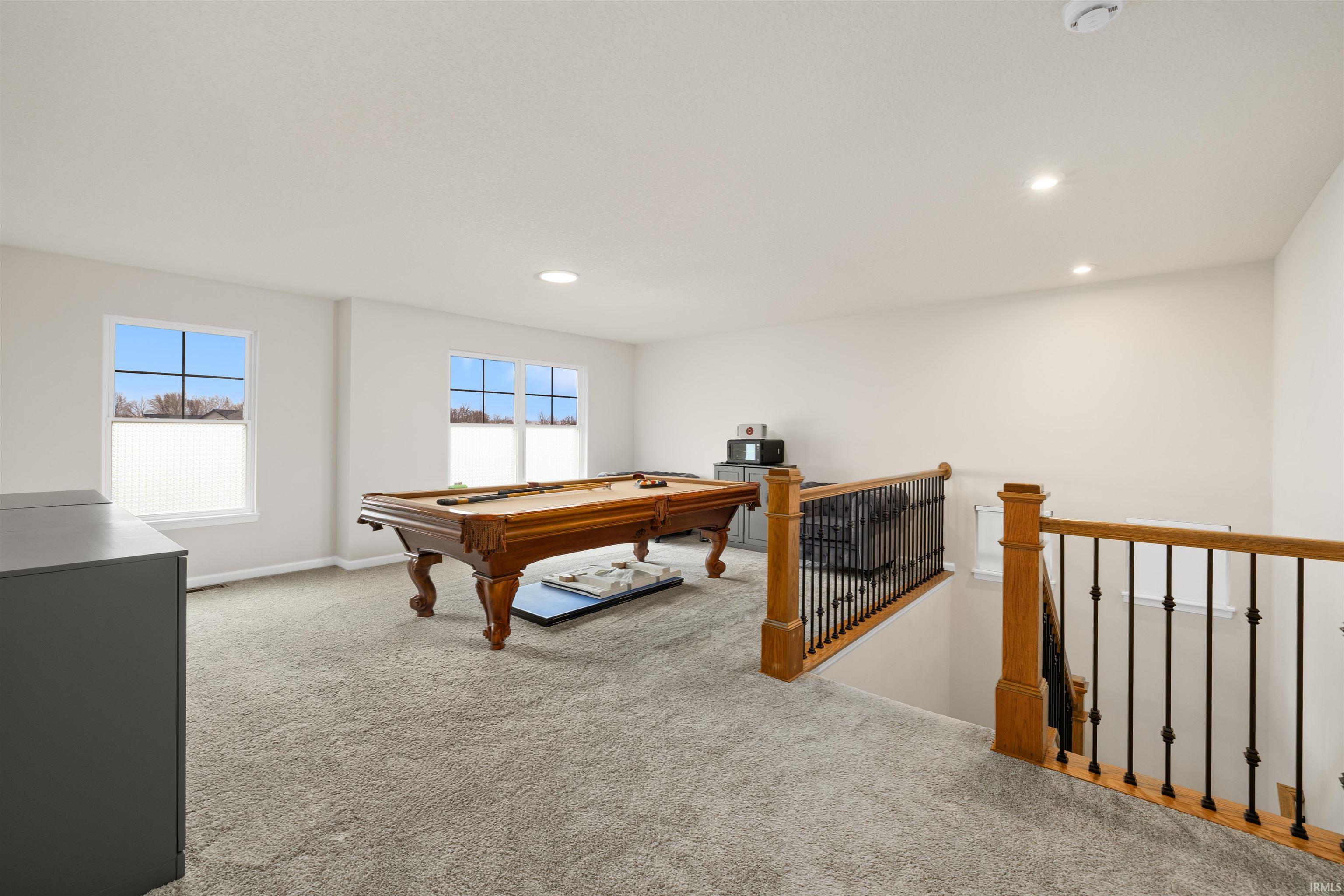 Playroom featuring light colored carpet, billiards, recessed lighting, and healthy amount of natural light