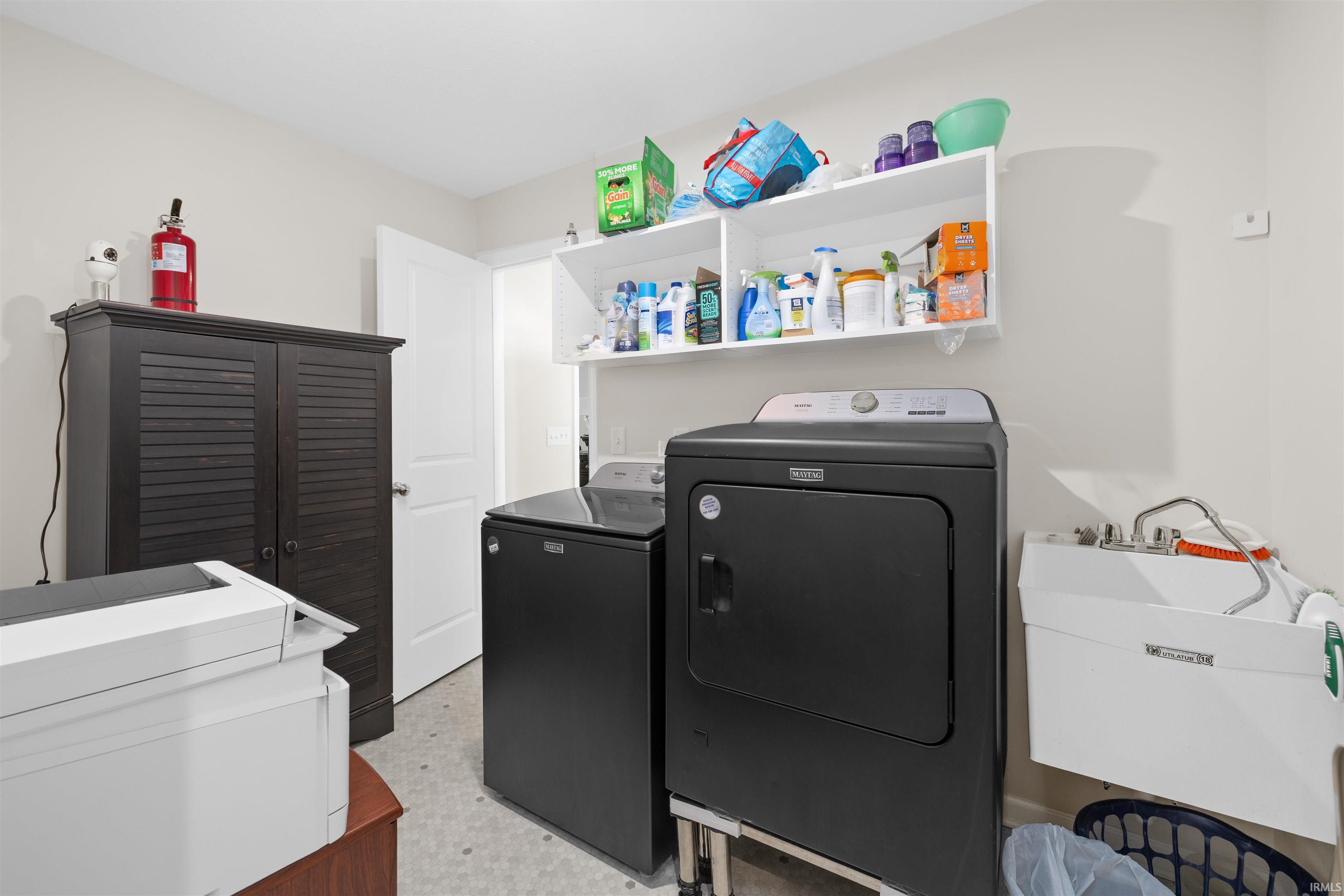 Laundry room with washer and clothes dryer